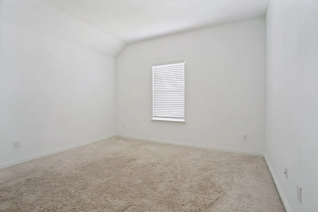 Room featuring neutral tone carpeting and crisp white walls