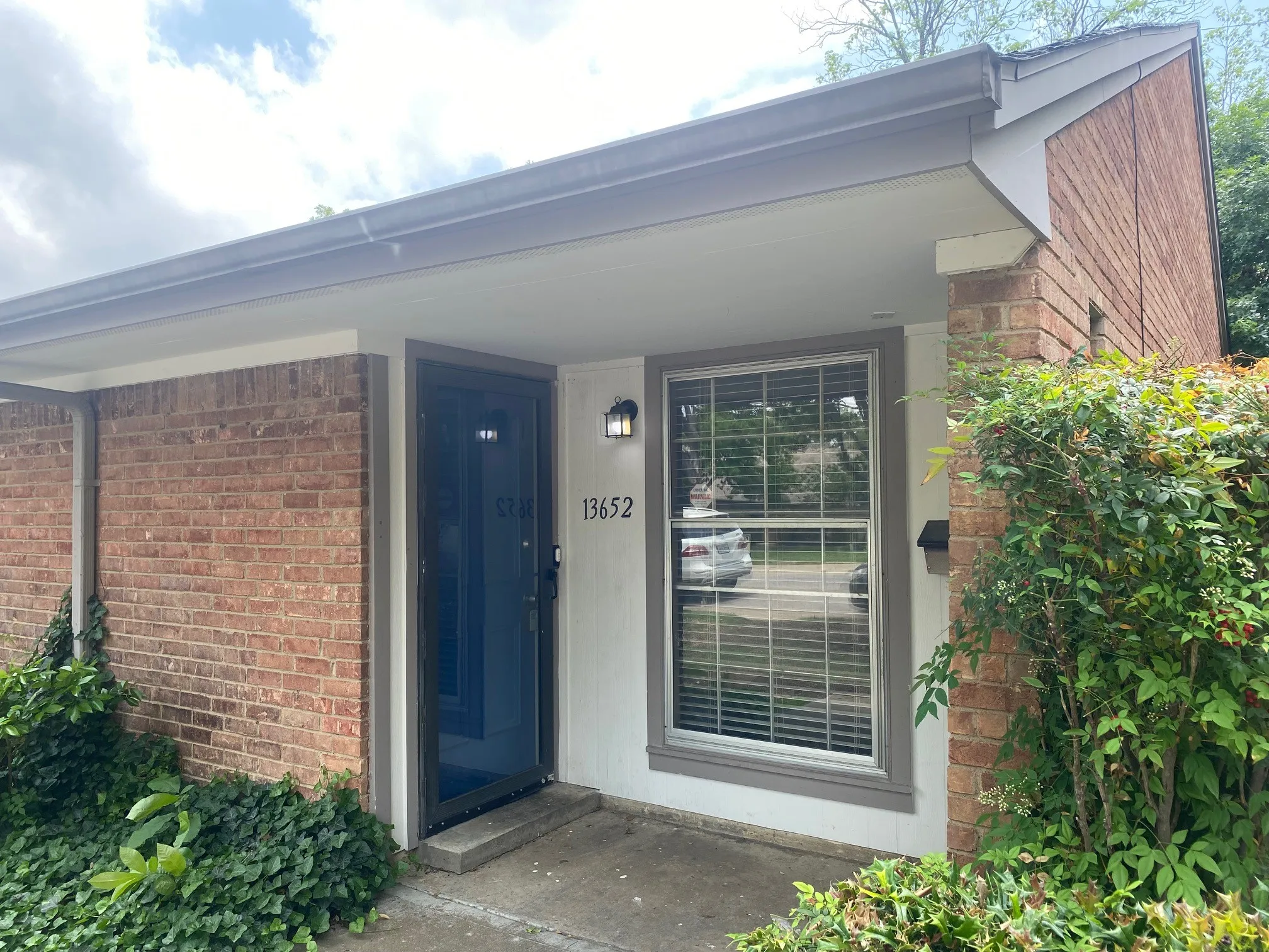 Entrance to property featuring brick siding
