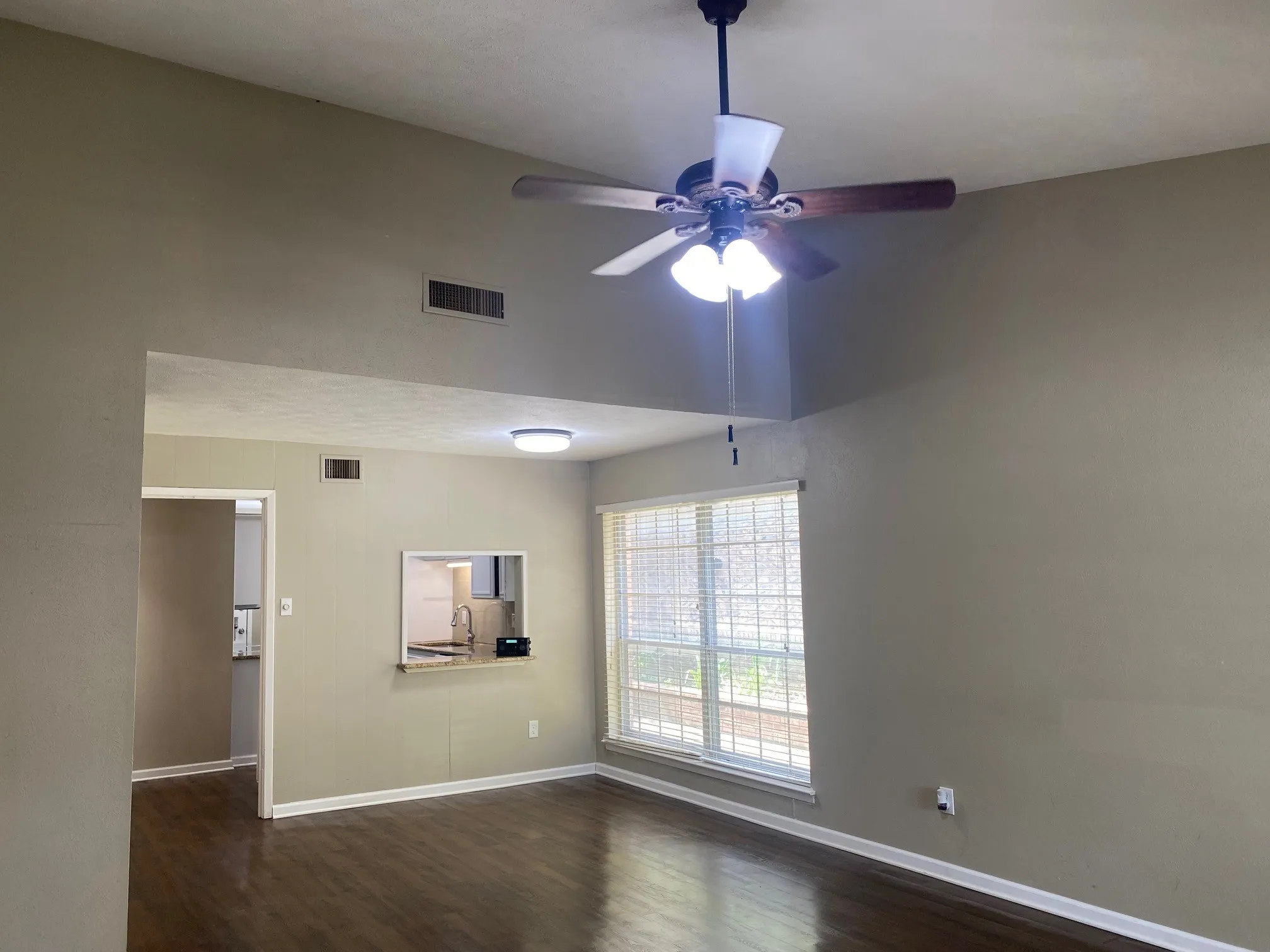 Unfurnished room with a ceiling fan and dark wood-style floors