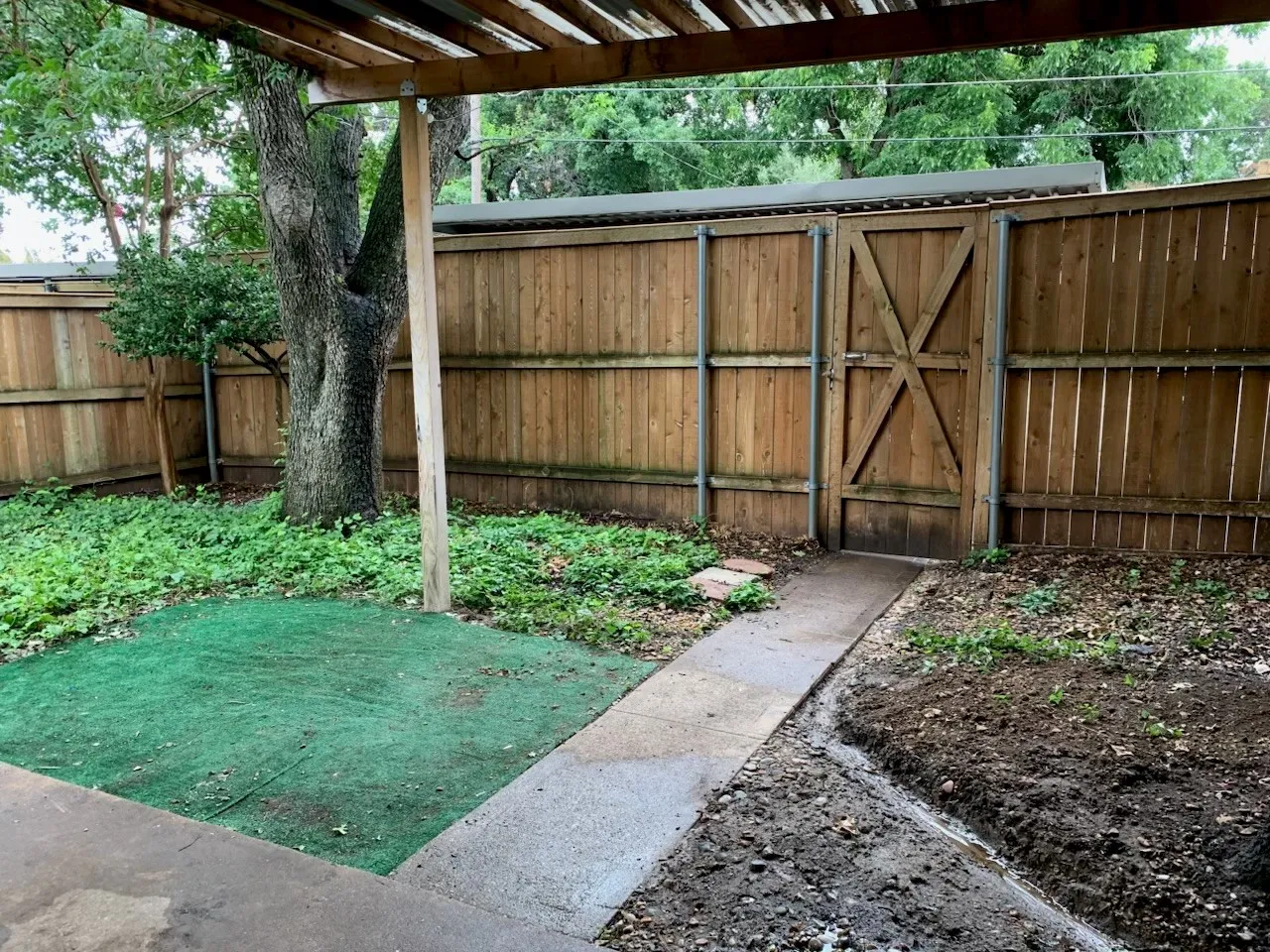 Fenced yard with a gate and a pergola