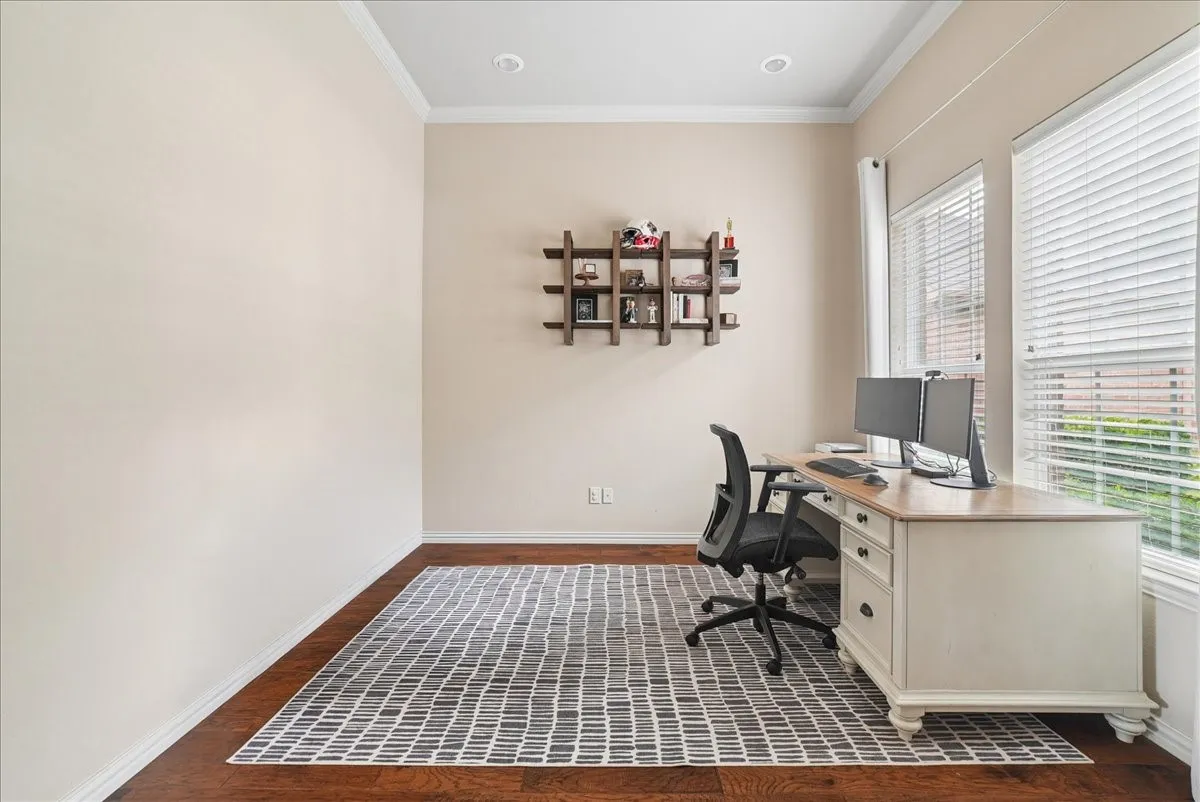 Dedicated room featuring wood-finish flooring, two large windows with blinds, recessed lighting, and crown molding