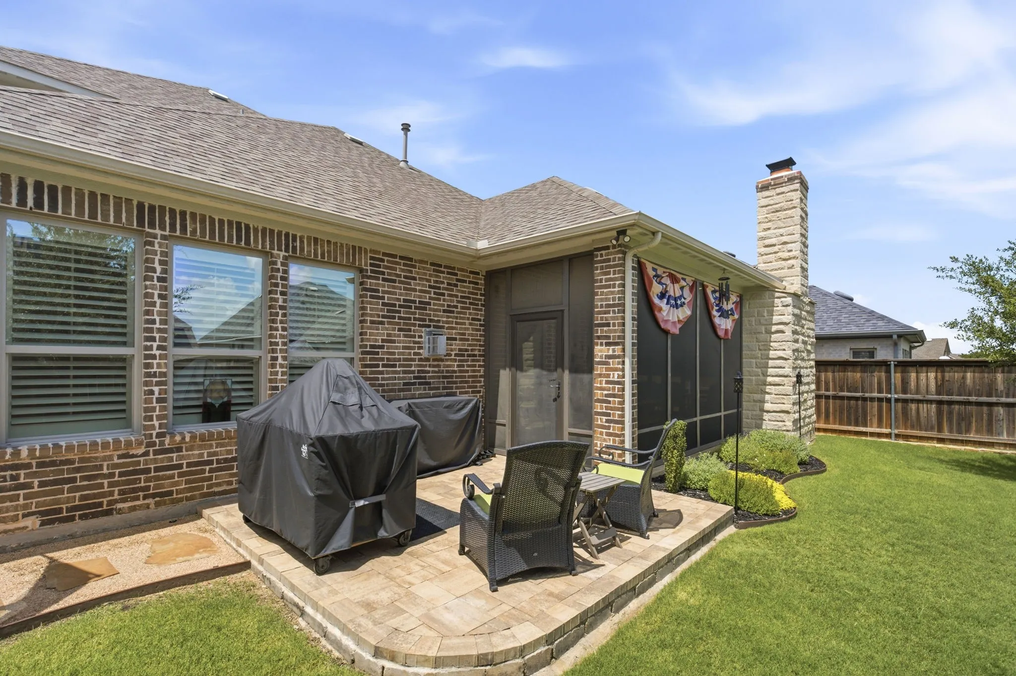 Adjacent to the screened porch, the 12x12 pavestone patio offers an additional outdoor gathering space ideal for grilling a sumptuous barbecue.