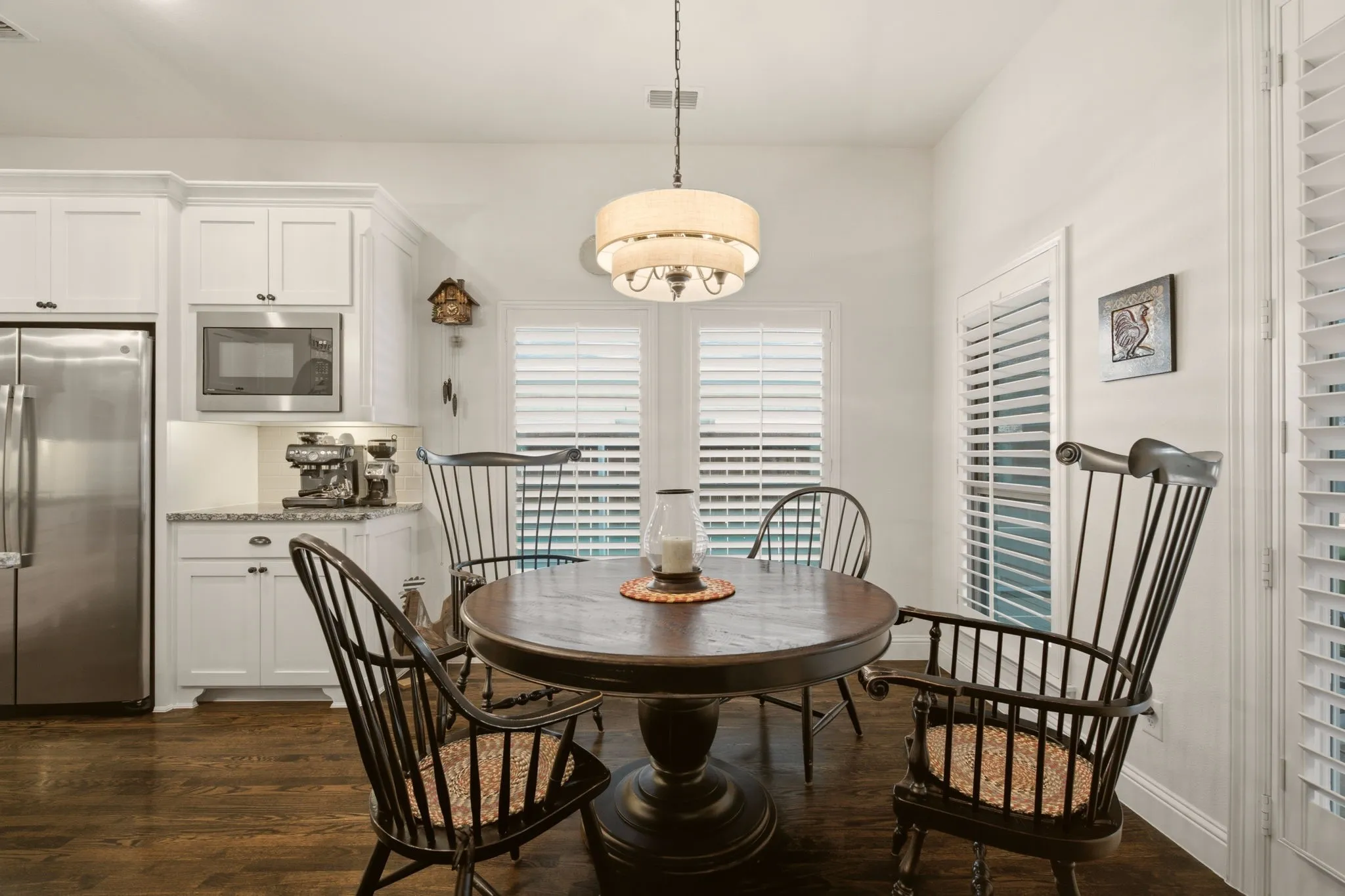 Just outside this cozy breakfast nook is the screened in porch. Open the right door & let the fresh air in!  Who doesn't love the look of handsome plantation shutters?