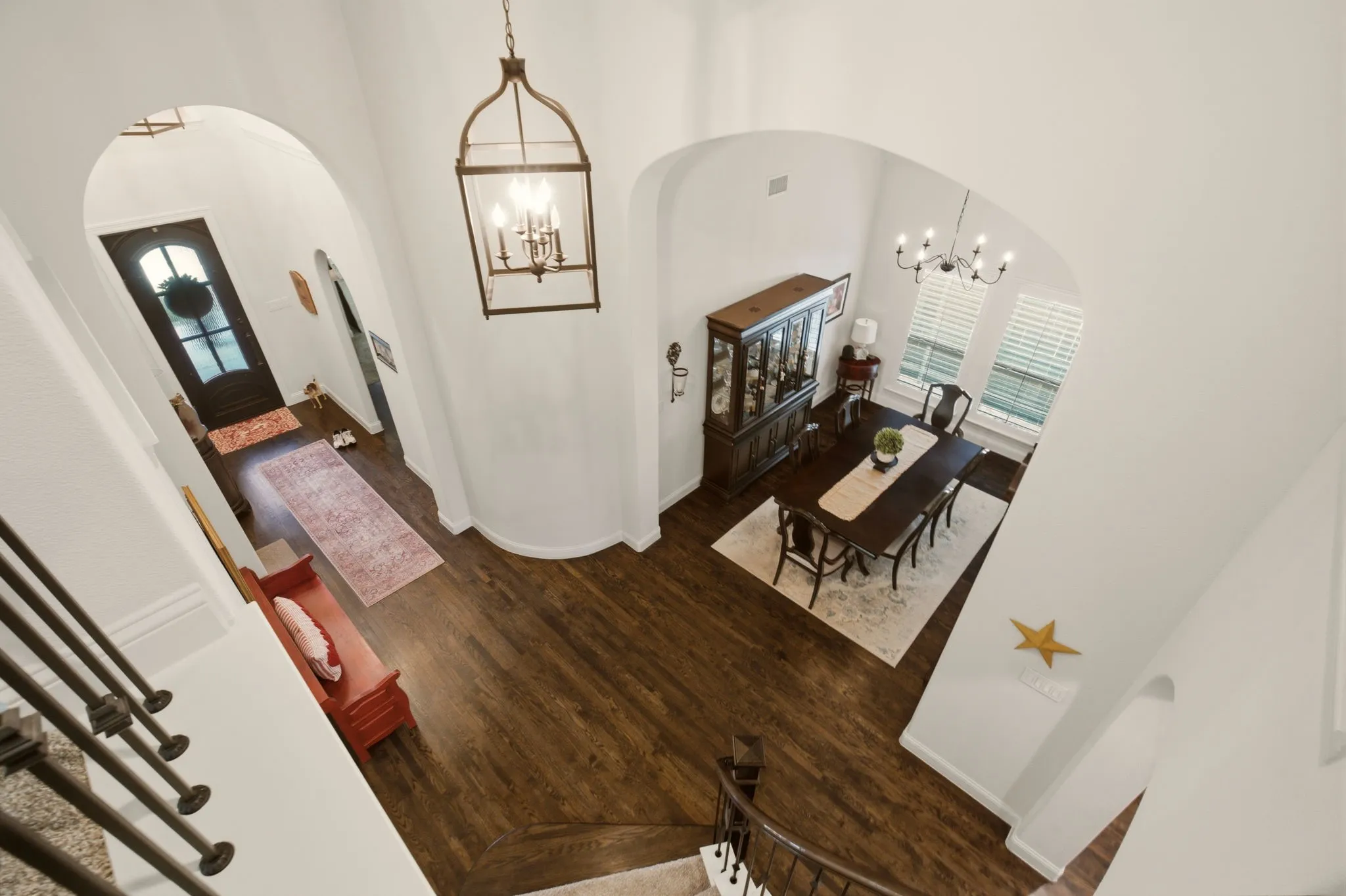 A aerial entry view to emphasize the soaring ceilings & light-filled ambiance in this floorplan.
