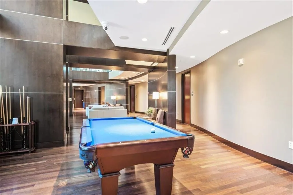 Billiards area featuring wood-finish flooring, recessed lighting, and a neutral wall palette