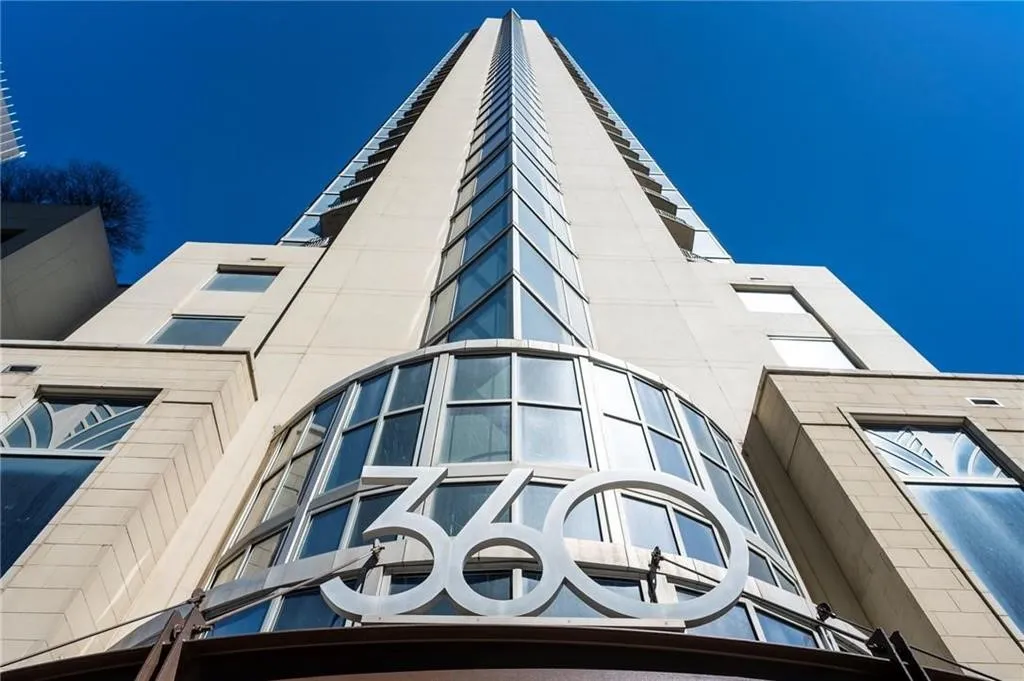 Modern high-rise building with a distinctive 360 facade sign