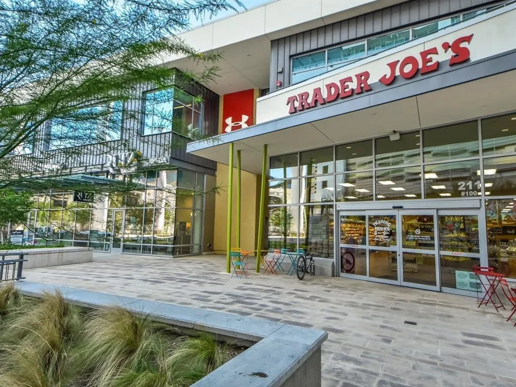 Contemporary commercial storefront featuring expansive glass windows and a prominent Trader Joe's sign