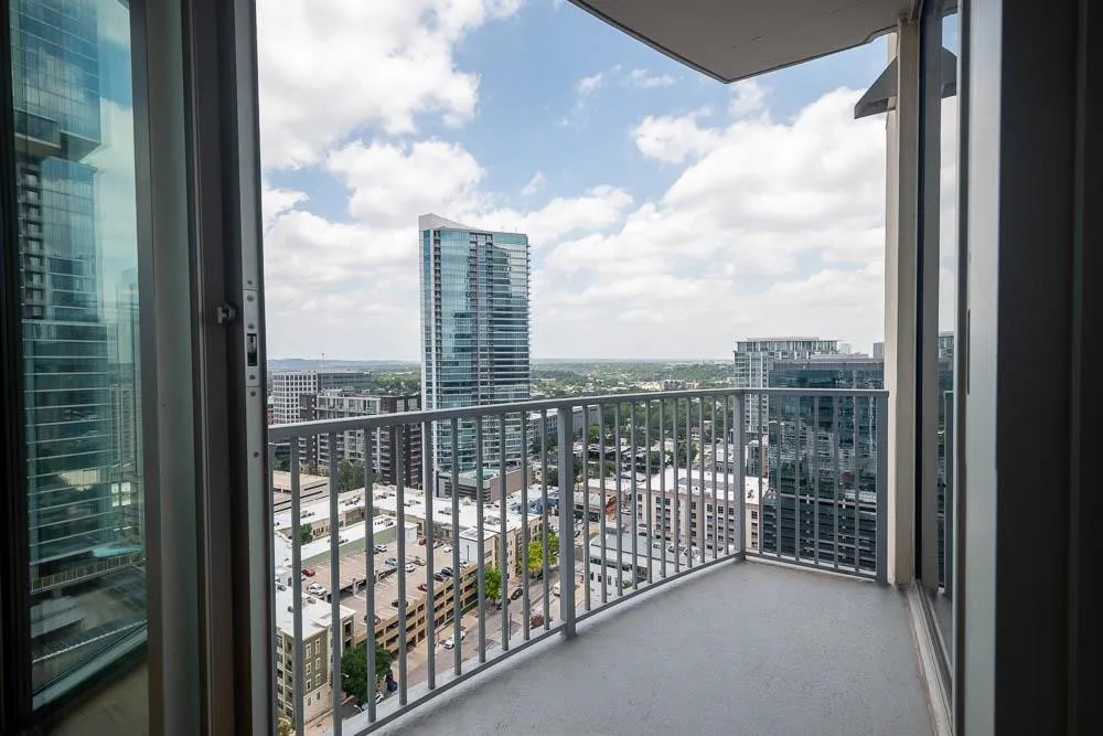 Private balcony featuring an open-air design and metal railing