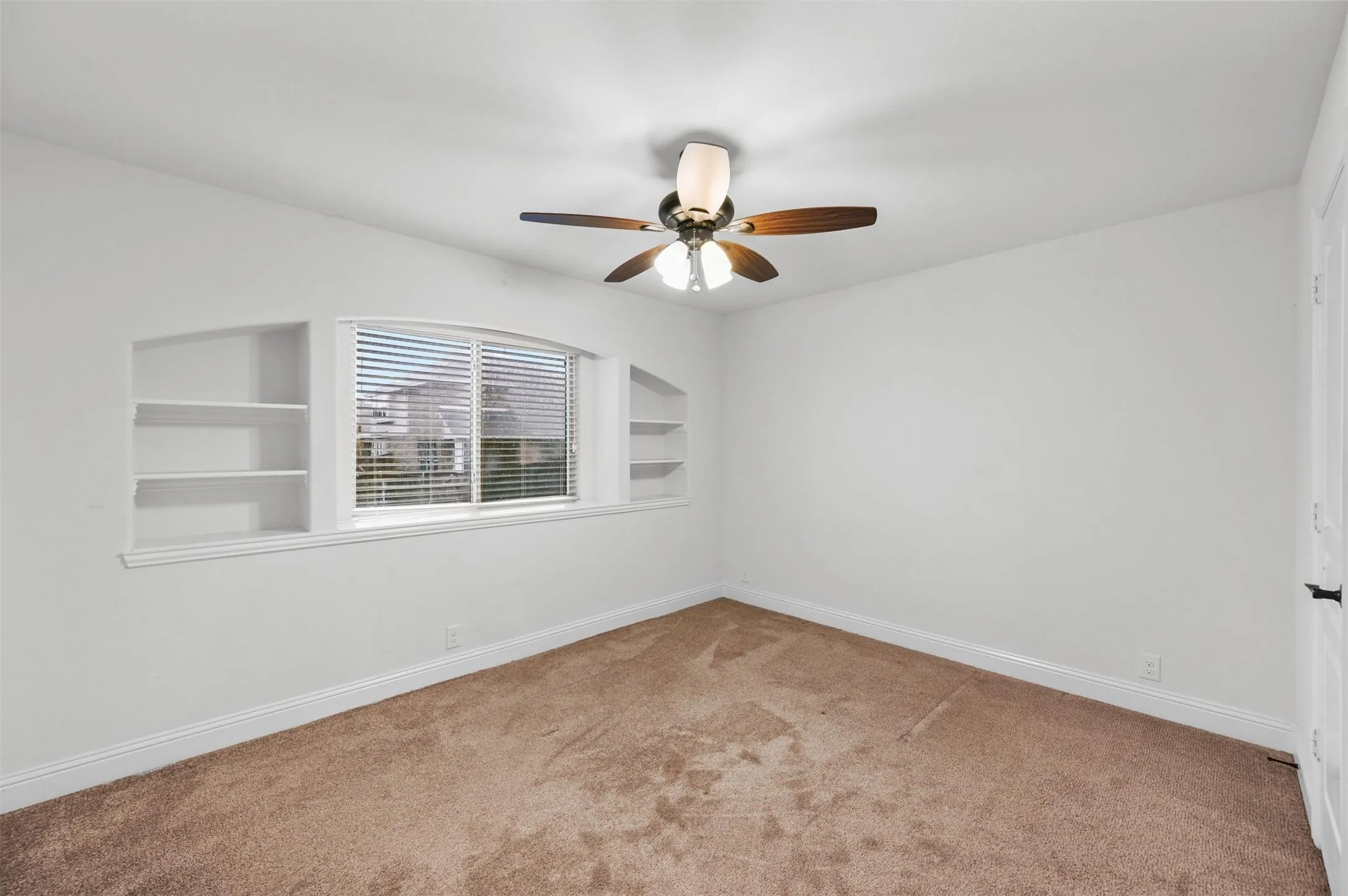 Bedroom #3
Horizontal blinds, flanked by built-in wall shelving on both sides