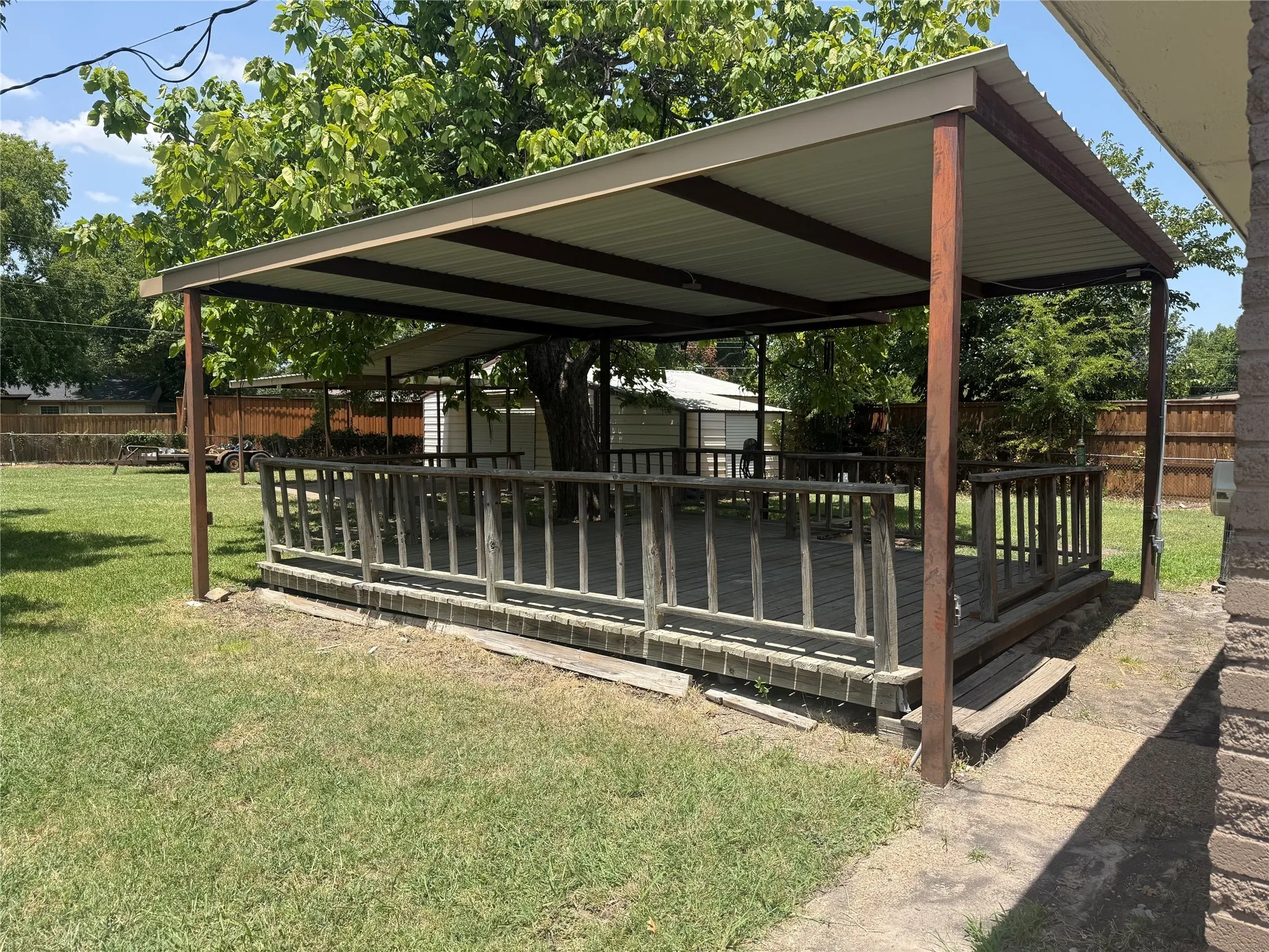 Wood deck with covered cooking space.