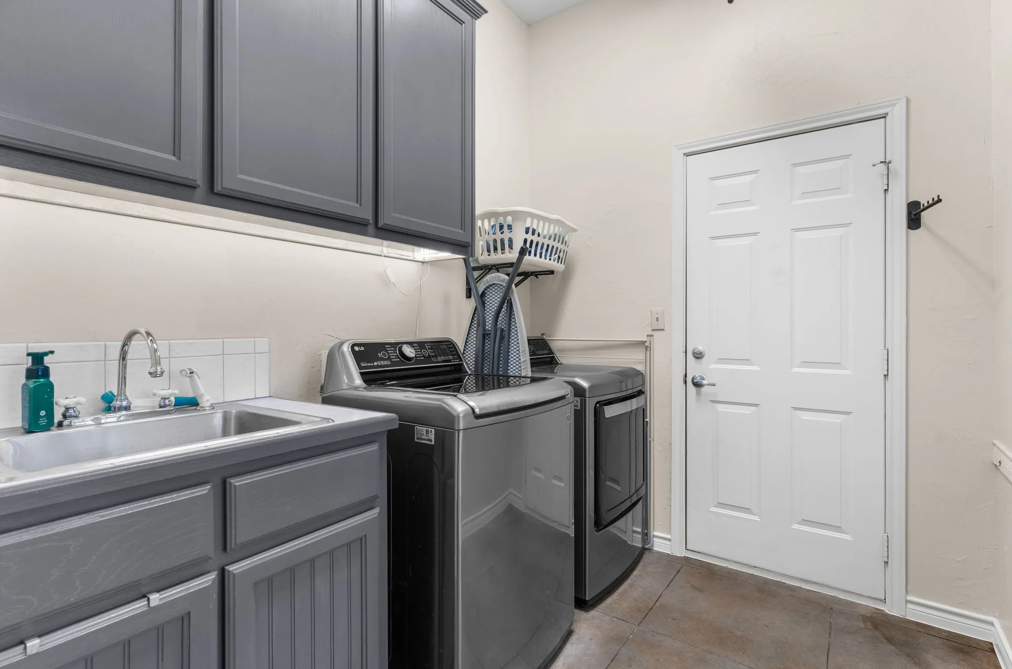 Laundry room features a sink and built-in storage!