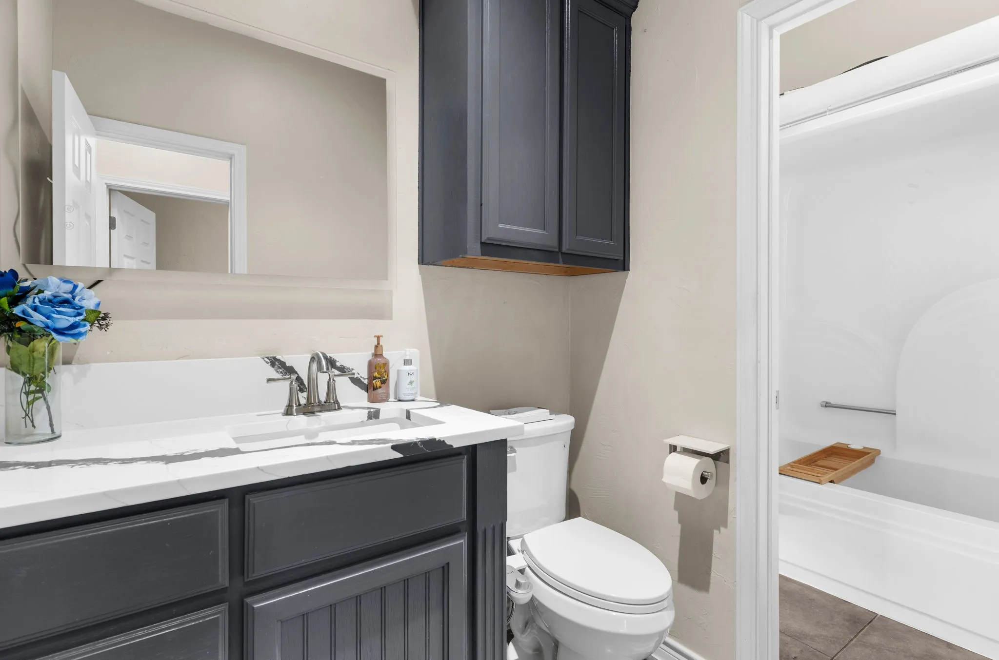 The home features a full bath with common area access complete with gorgeous, modern finishes.