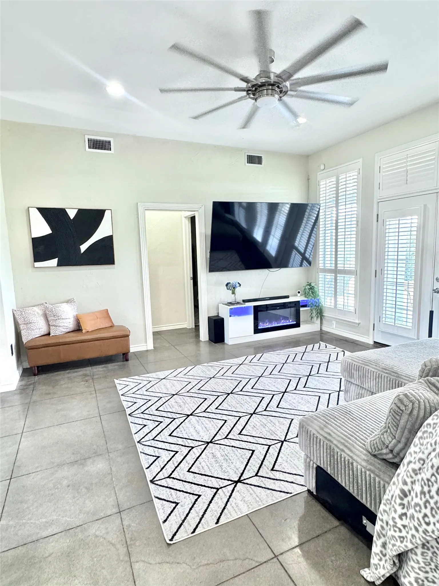 The living room features large windows that overlook the beautiful property and fill the space with natural light!