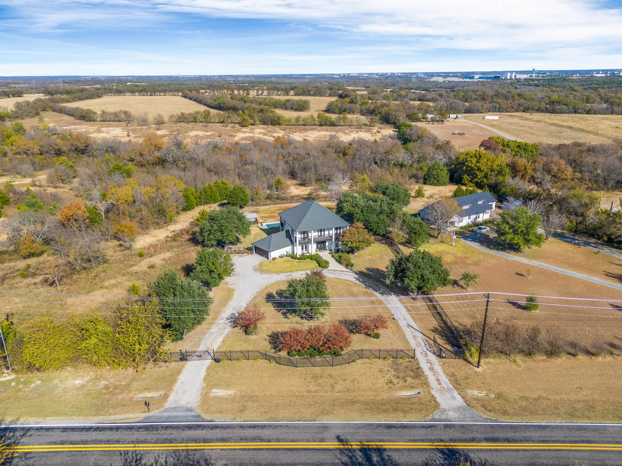 The entire property is secured by a 6-foot iron fence with two electric front entry gates.