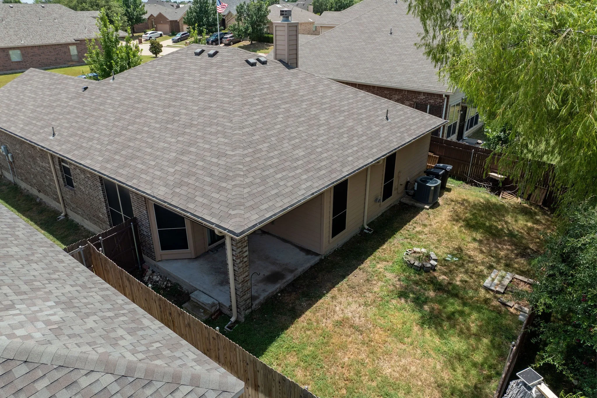 Rear exterior with a covered patio, screens, and a shingle roof