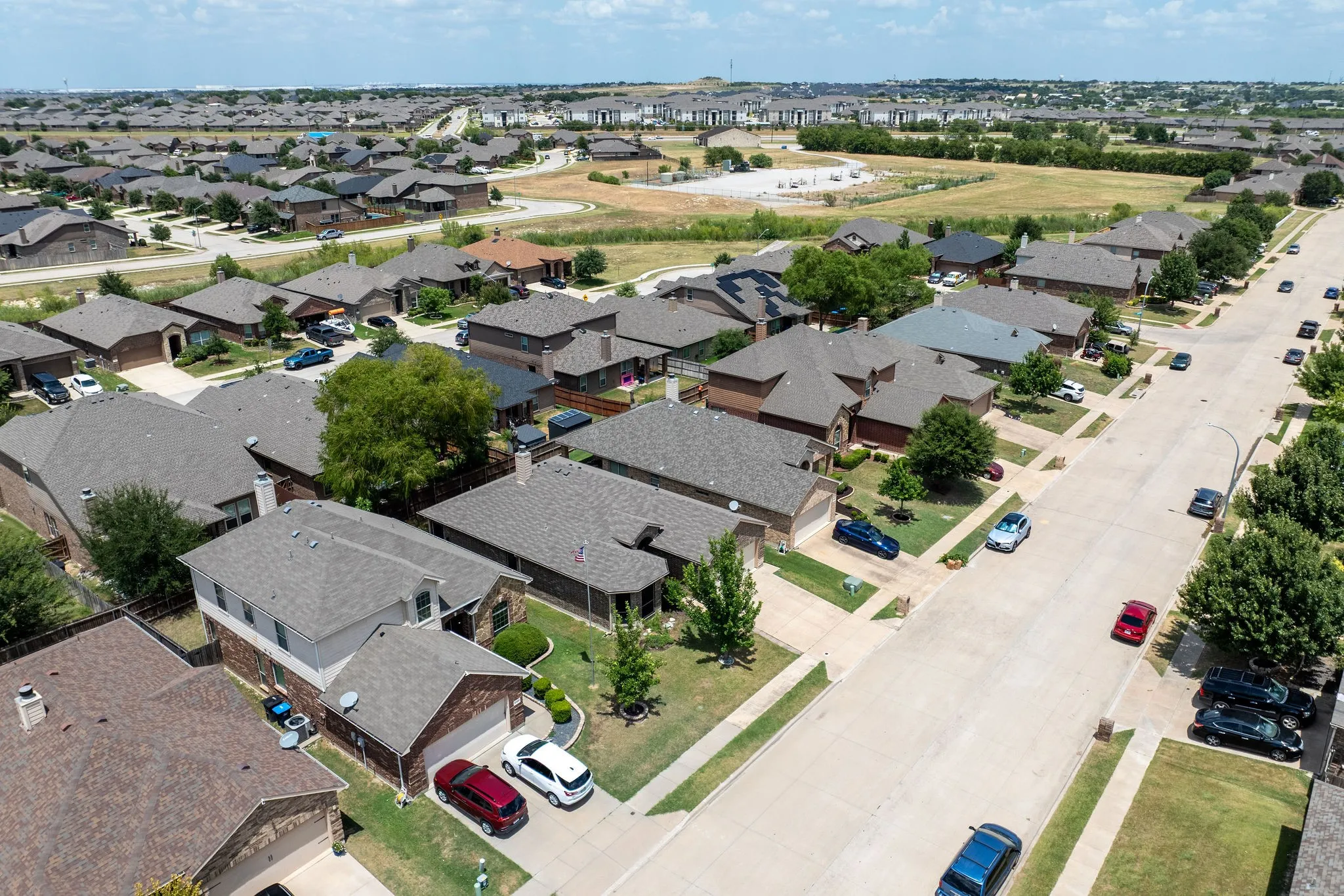 Aerial view showcasing a residential development with numerous single-family homes