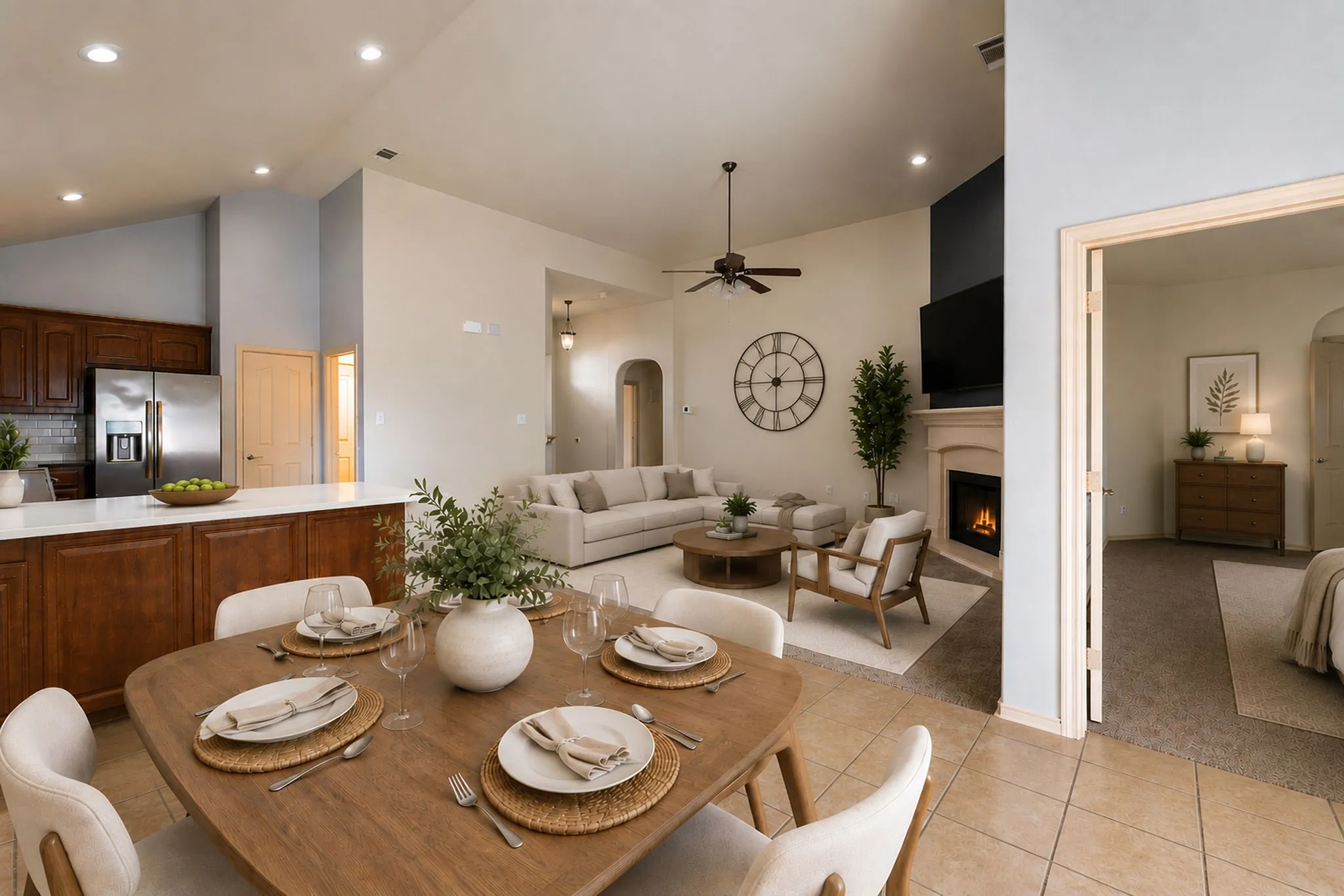 Virtual Staging of open living room and dining.  Open-concept living area featuring vaulted ceilings, recessed lighting, a fireplace with a mantel, and a kitchen island with seating