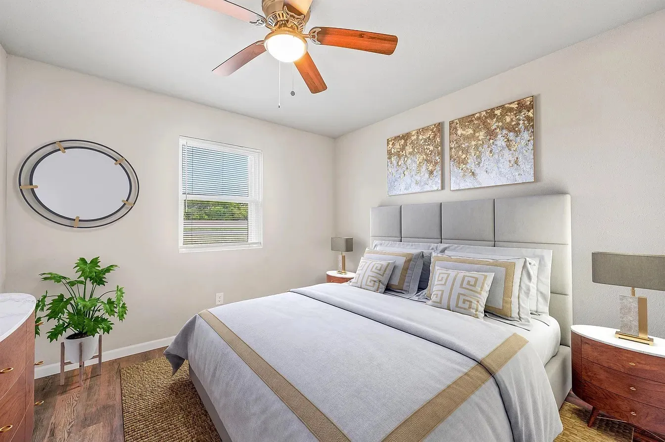 Bedroom featuring wood-finish flooring, a ceiling fan with integrated lighting, and a single window with blinds