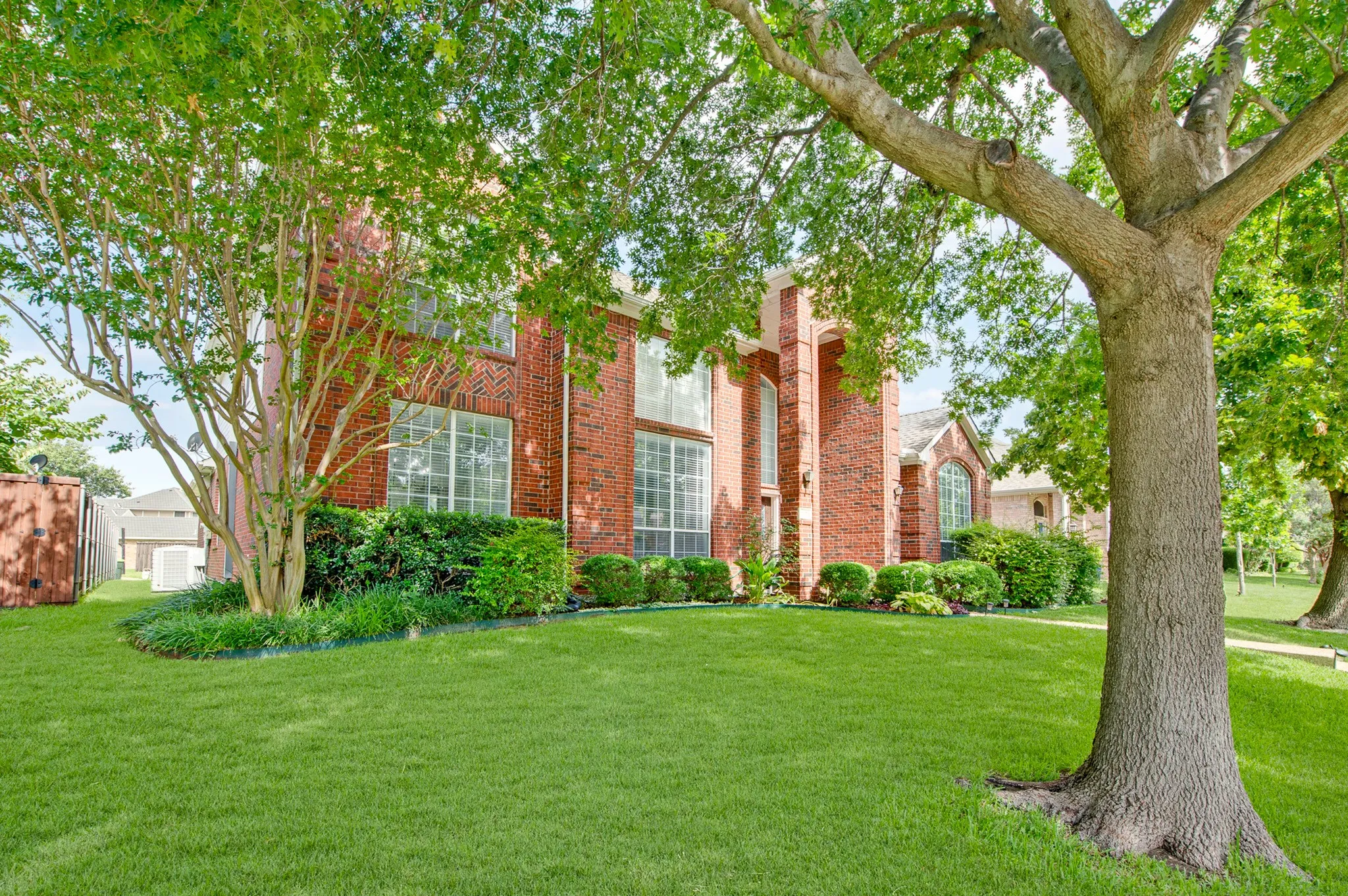 Red brick exterior featuring multiple large windows and decorative architectural arches
