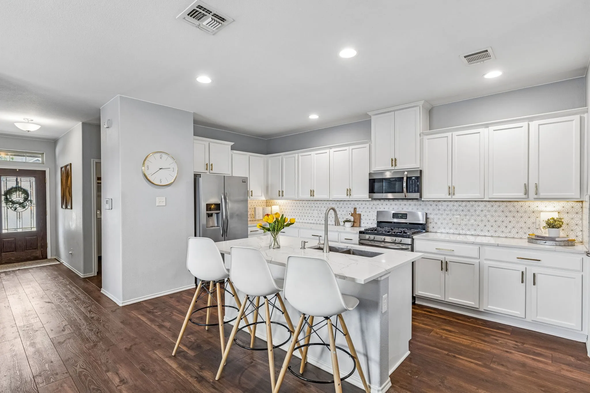 updated kitchen with marble backsplash and upgraded countertops and hardware