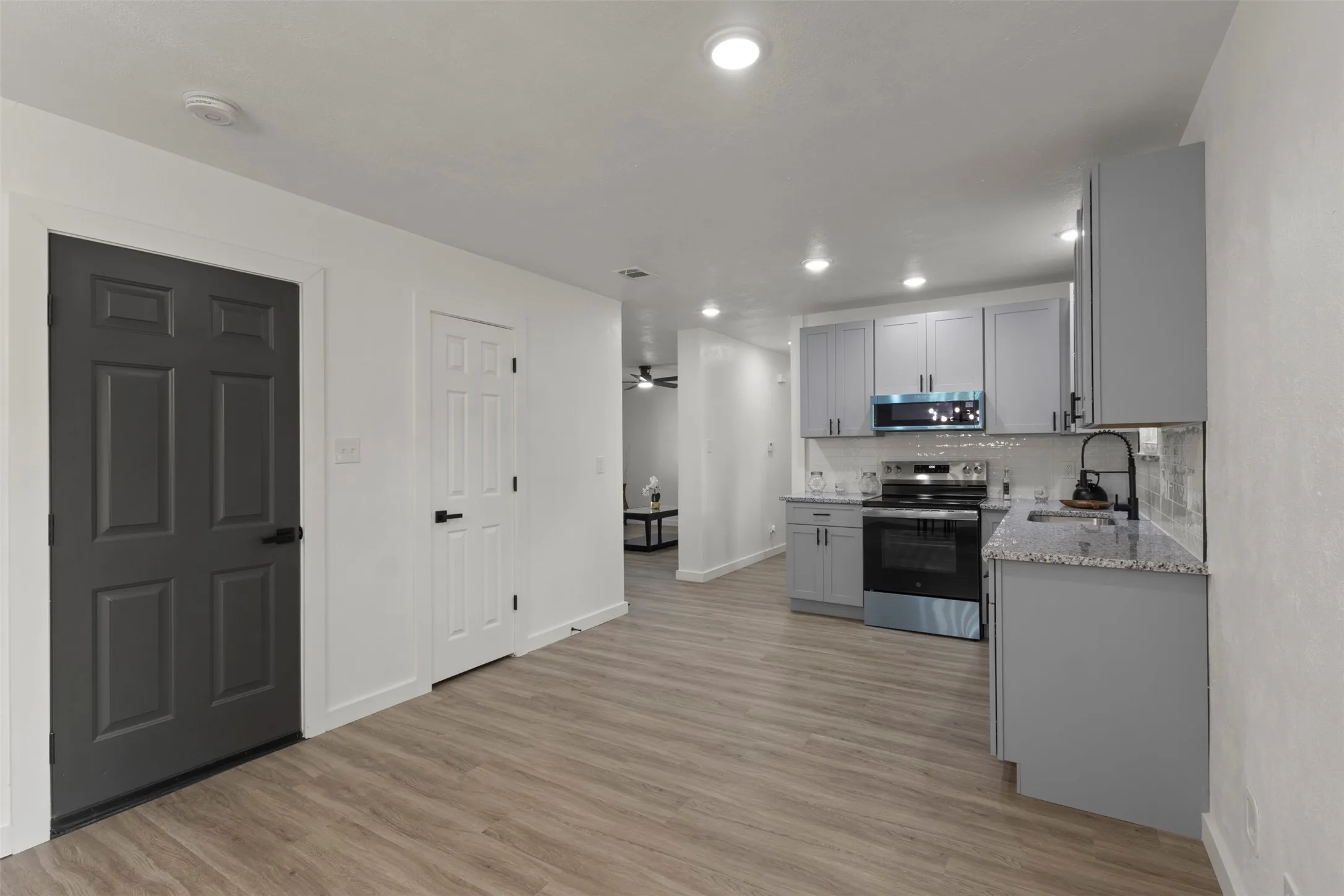 Kitchen connect to living room , door that leads to the garage.