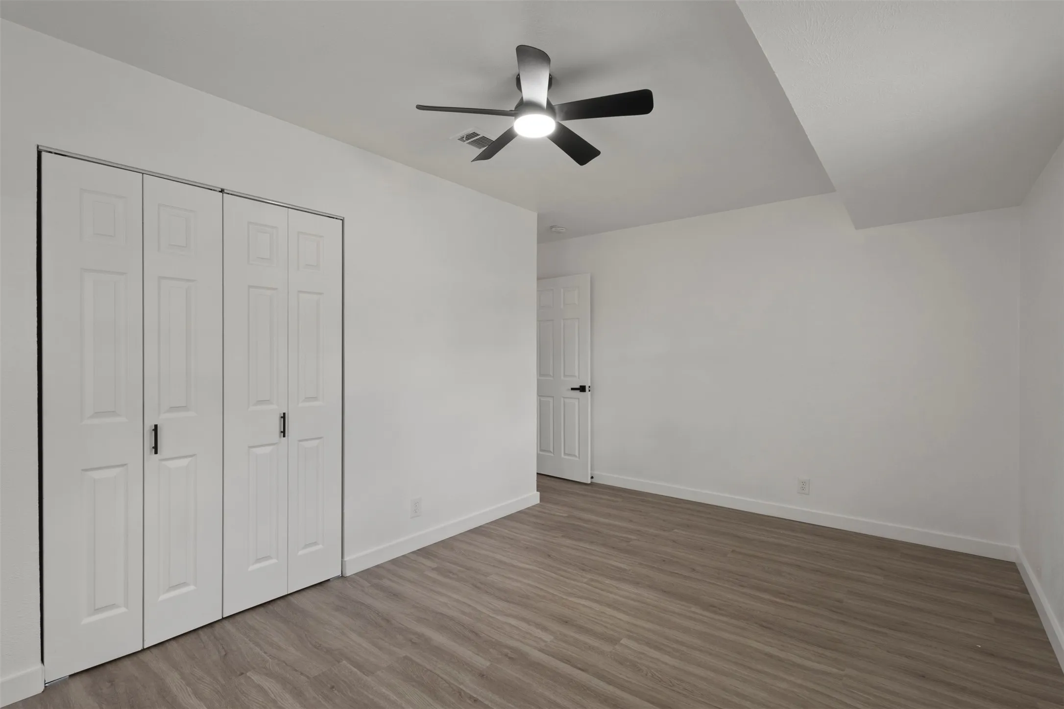 secondary bedroom with a double sliding door closet