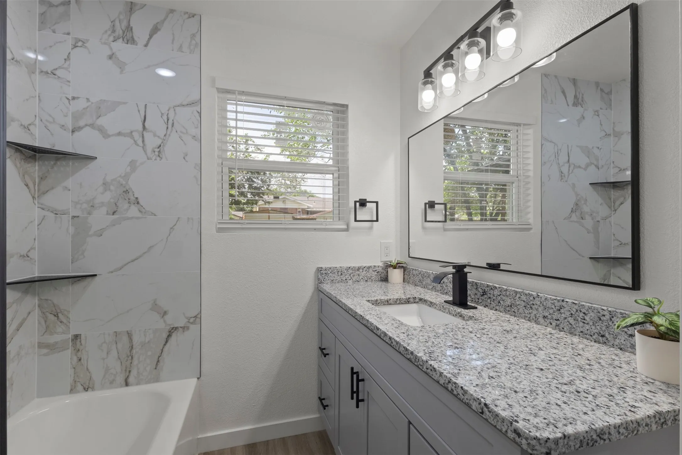 First full bath with granite countertops and a vanity