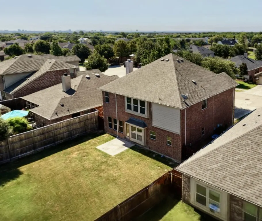 Two-story brick exterior with a multi-pane window bay
