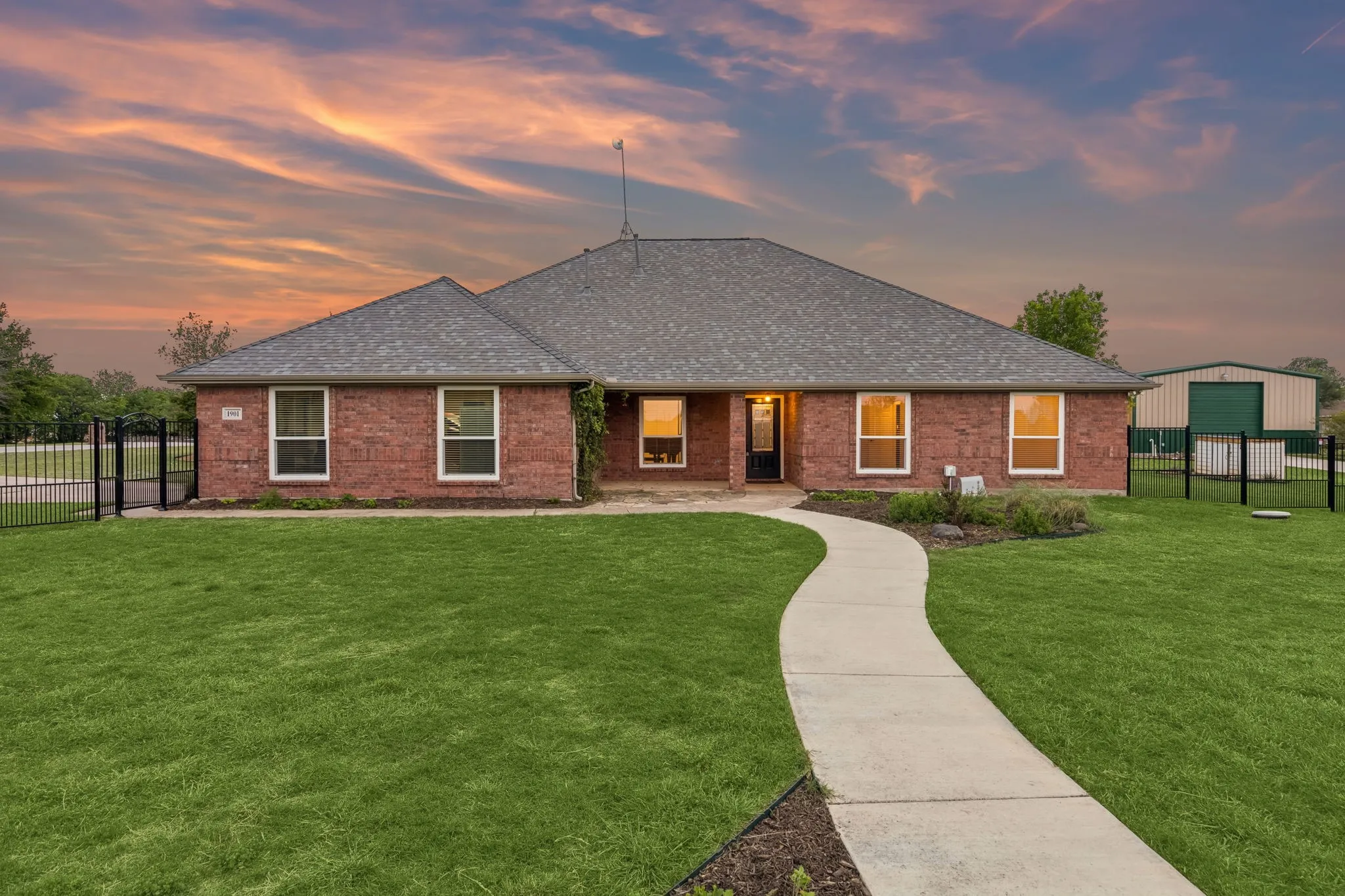 Stunning Homesite Framed By Lush Landscaping And Iron Fencing