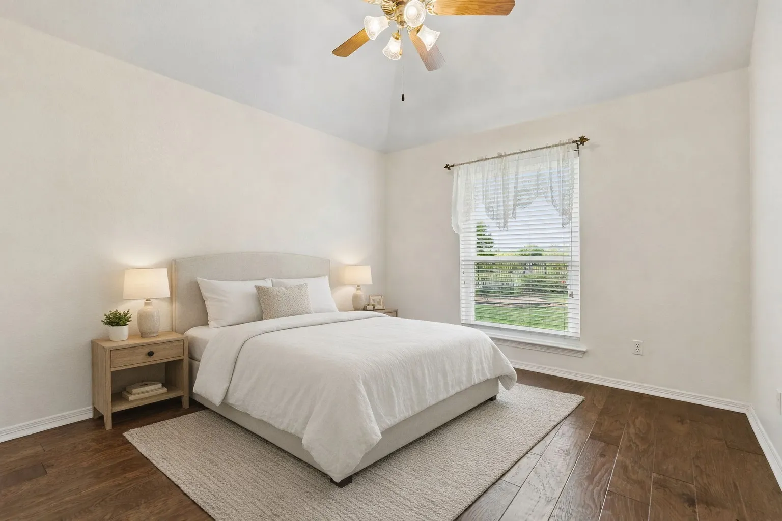 Cozy Secondary Bedroom With Wood Floors And Ceiling Fan