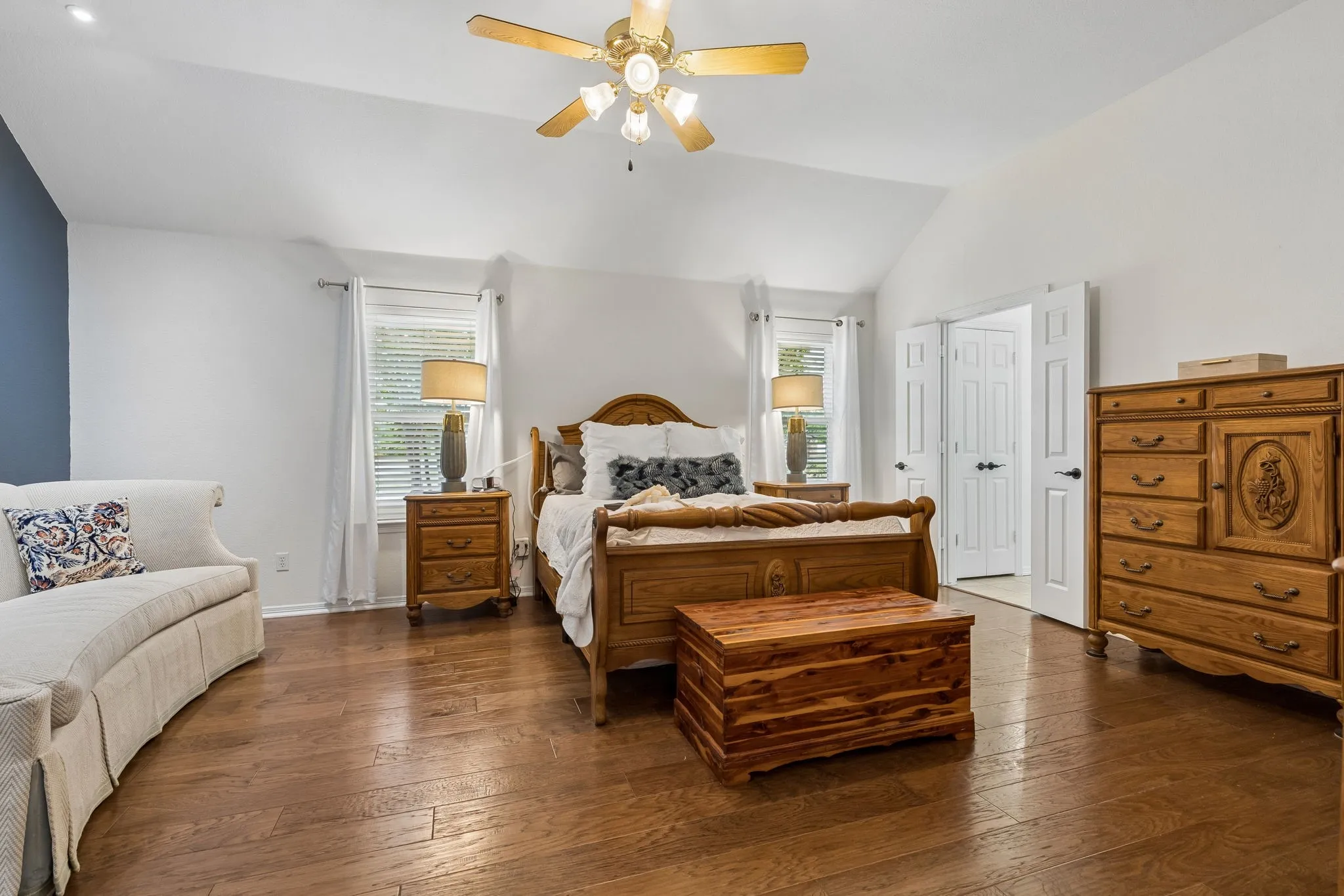 Spacious Primary Suite With Wood Floors, Vaulted Ceilings, And Natural Light