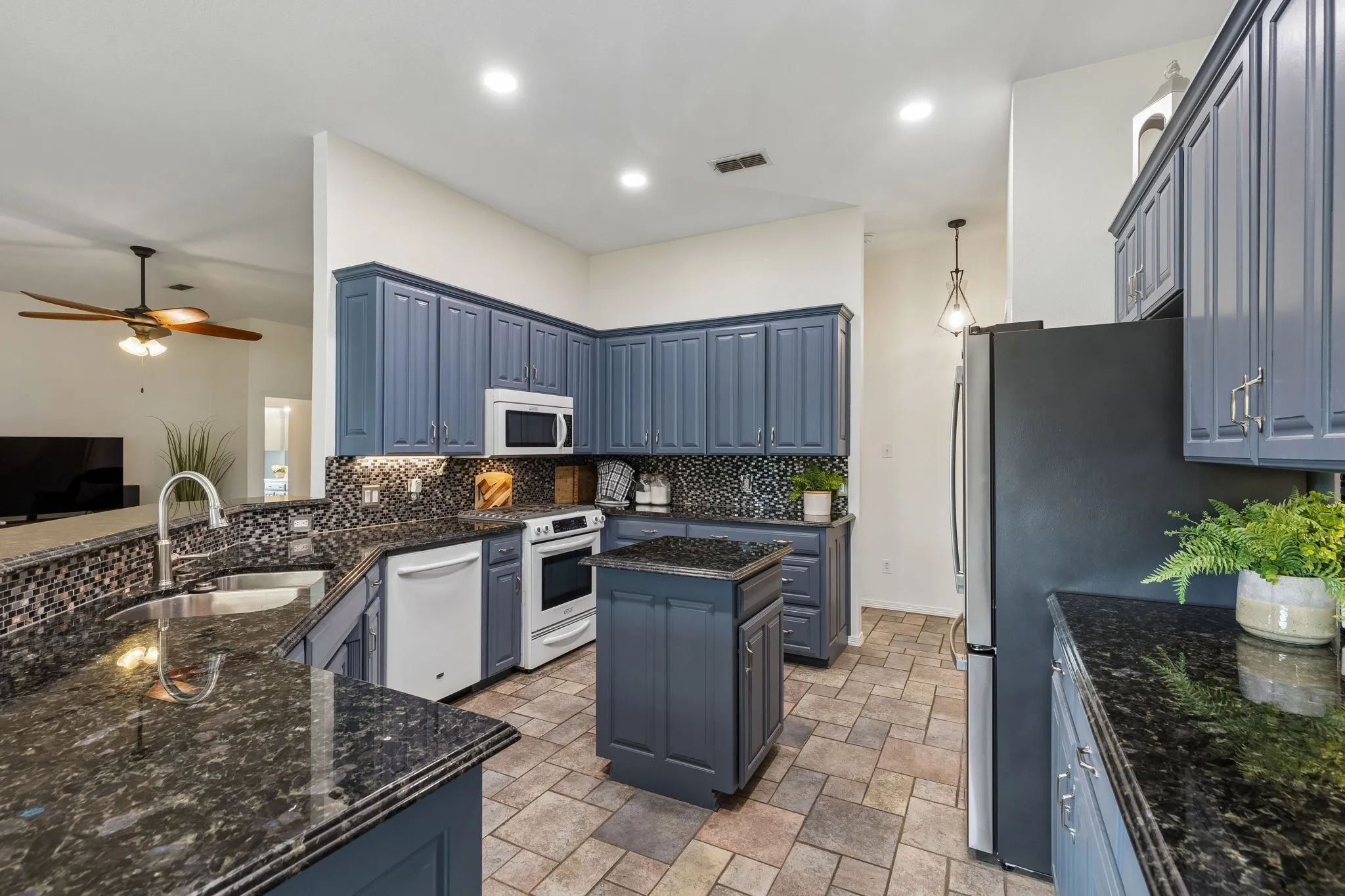 Updated Kitchen With Custom-Painted Cabinets, Granite Counters, And Mosaic Backsplash