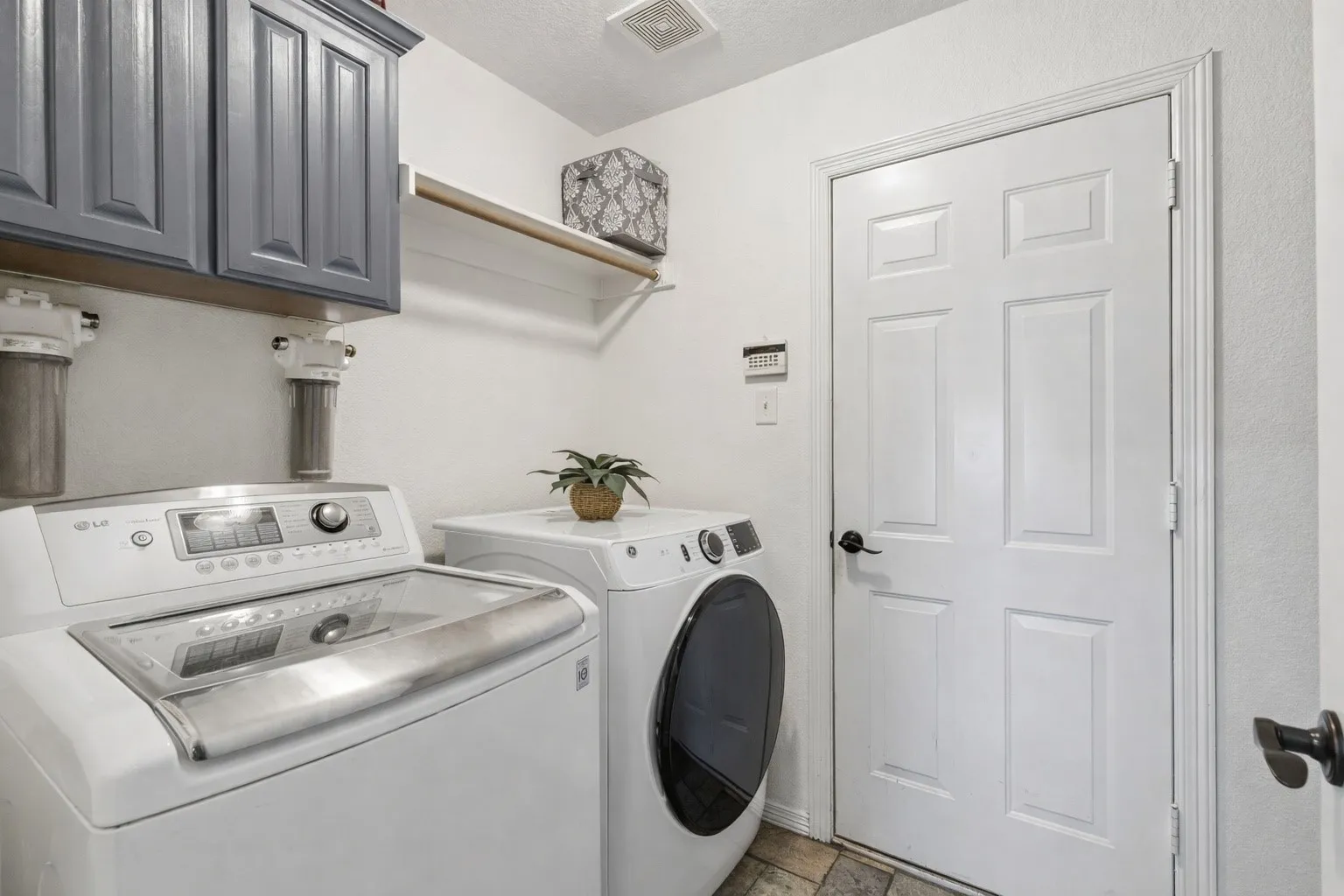 Large Laundry Room Featuring Cabinetry