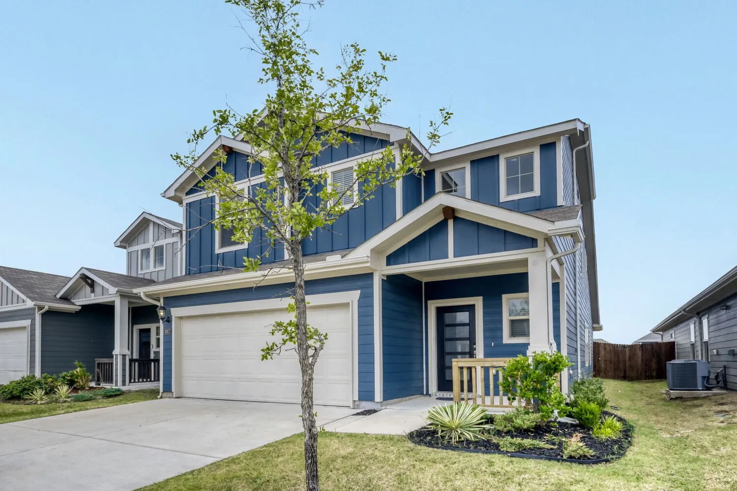 Contemporary two-story residence with a deep blue exterior and white trim
