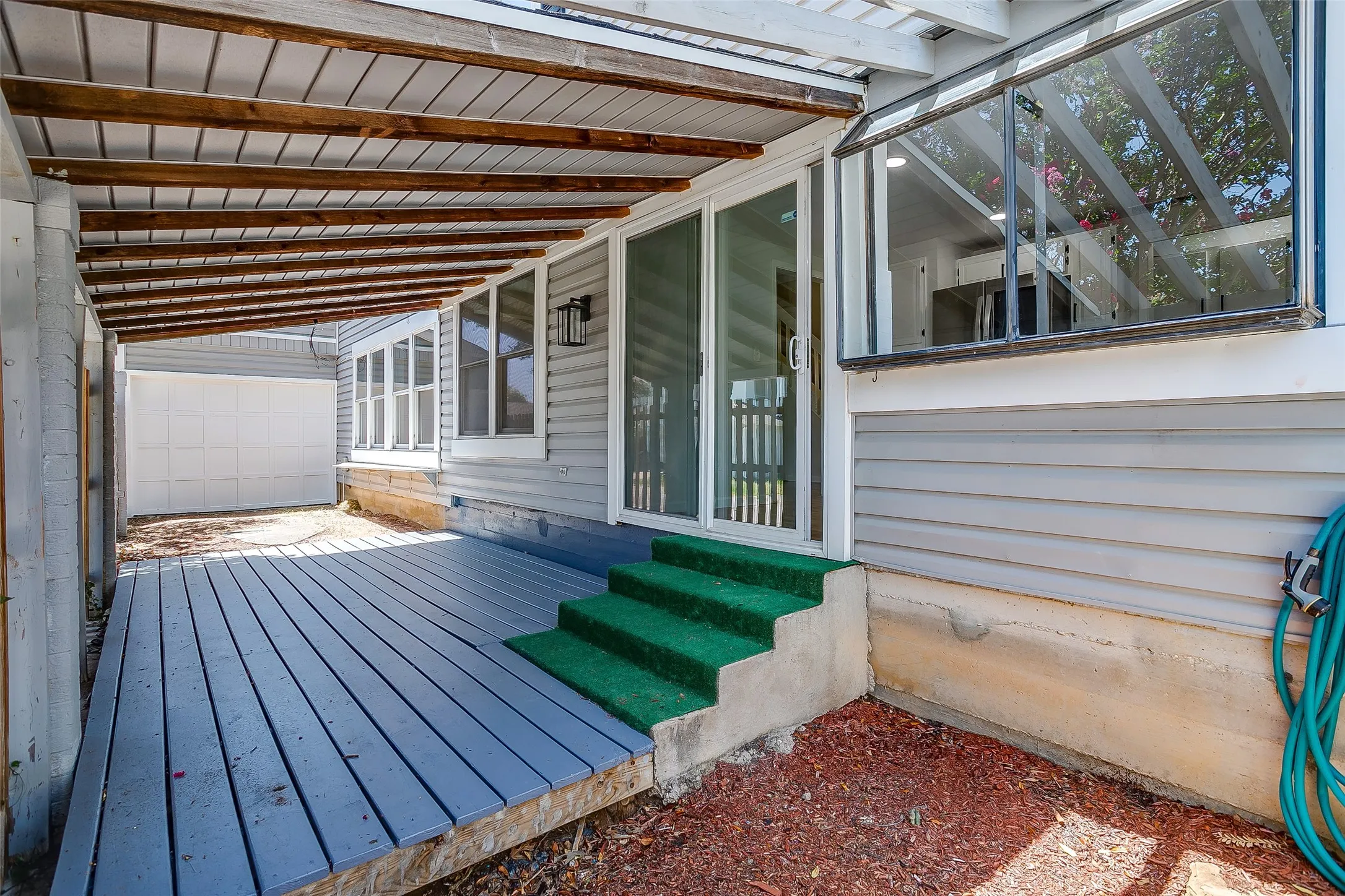 Covered wood deck, ideal for lakeside evenings.
