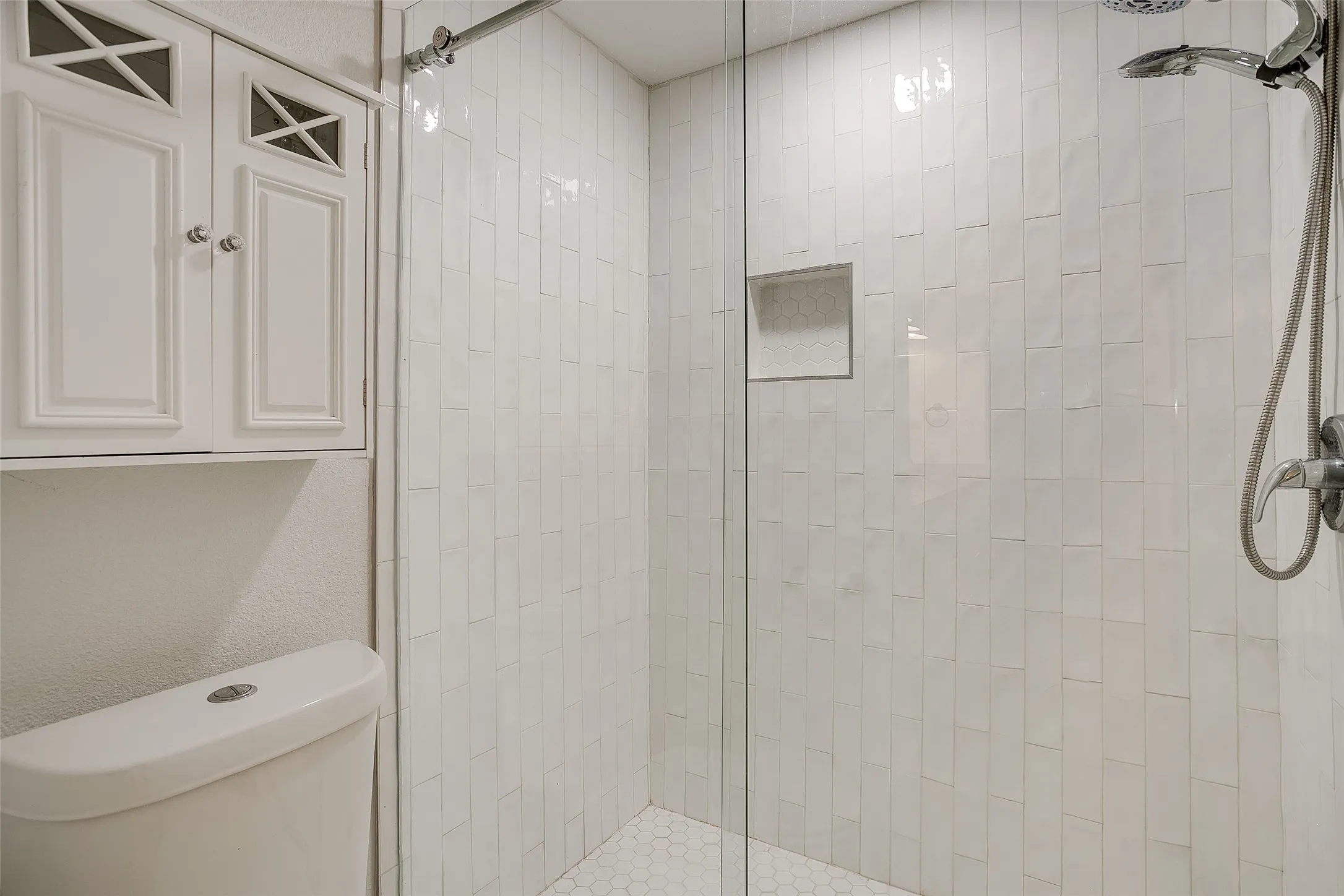 Walk-in shower in the first-floor primary bath.