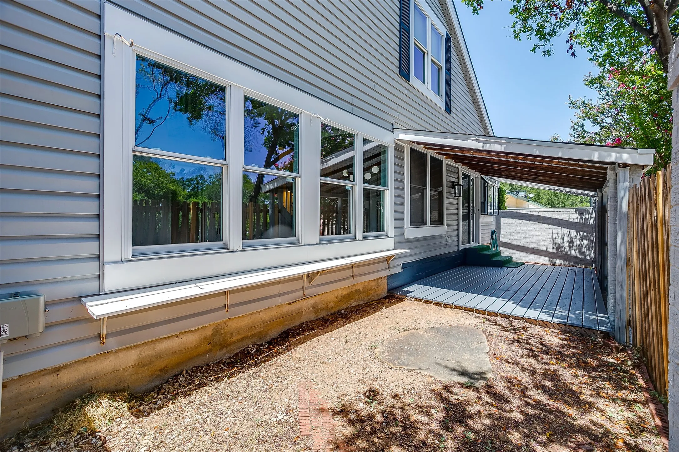 Expansive back deck spanning the rear of the home.