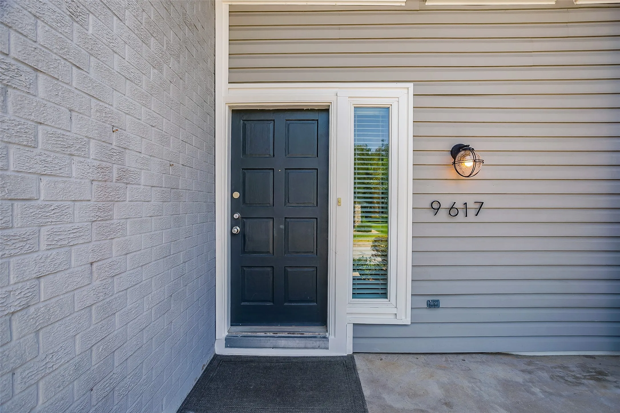 Covered front entry with classic door at 9617 Lea Shore St.