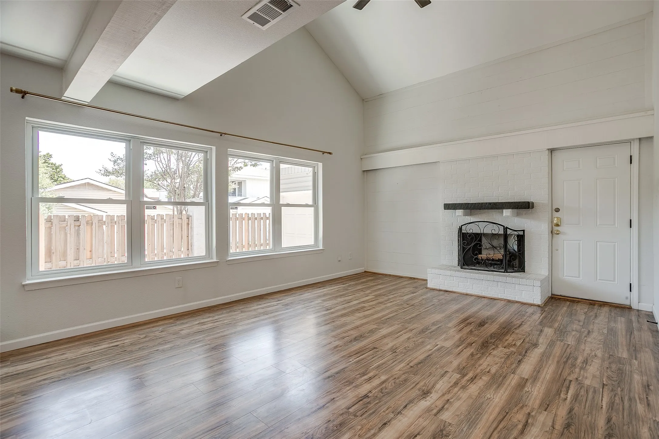 Light-filled living room with fireplace and shiplap accent wall.