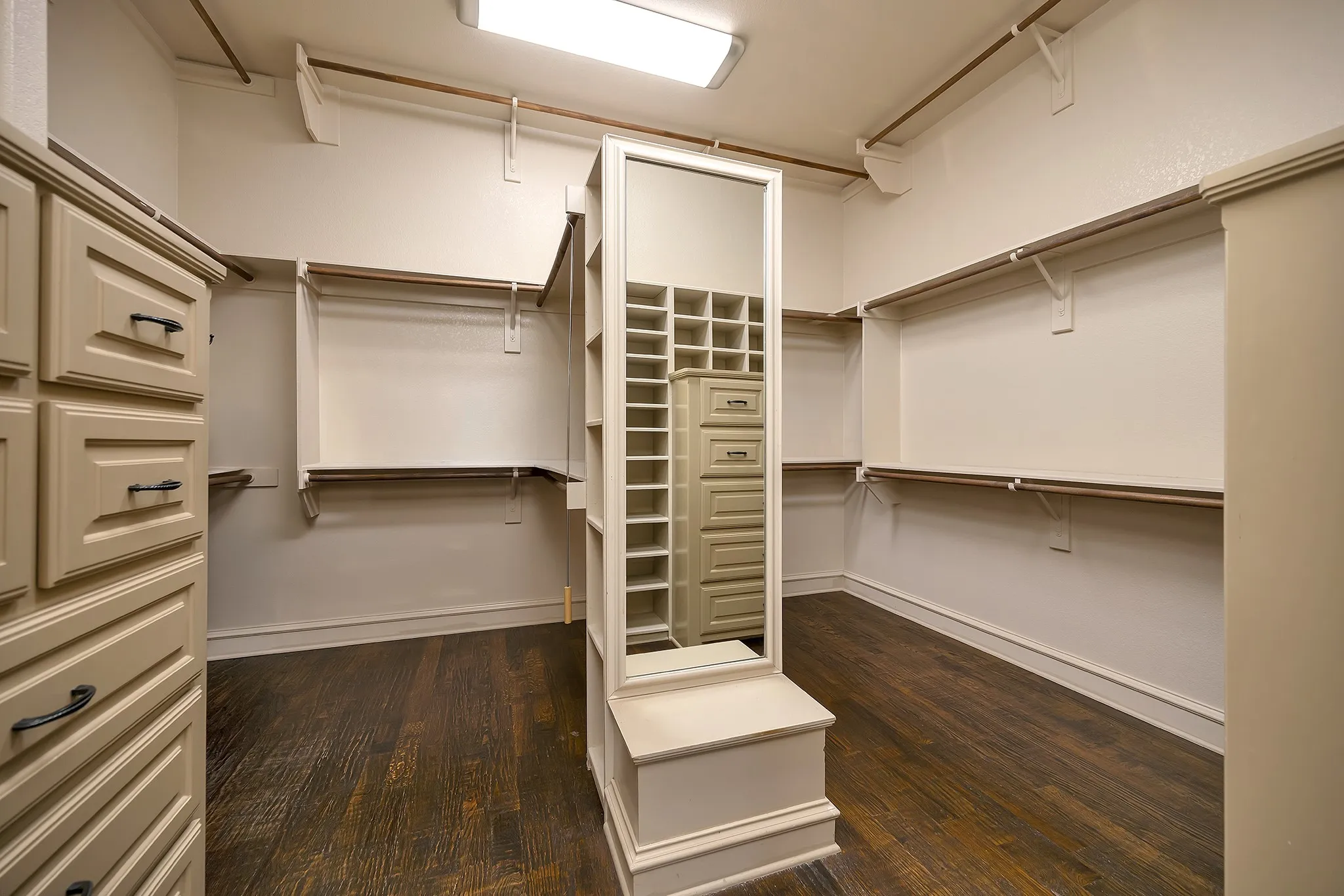 Primary Closet is Cavernous with Custom Built-in Dressers and Shelving.