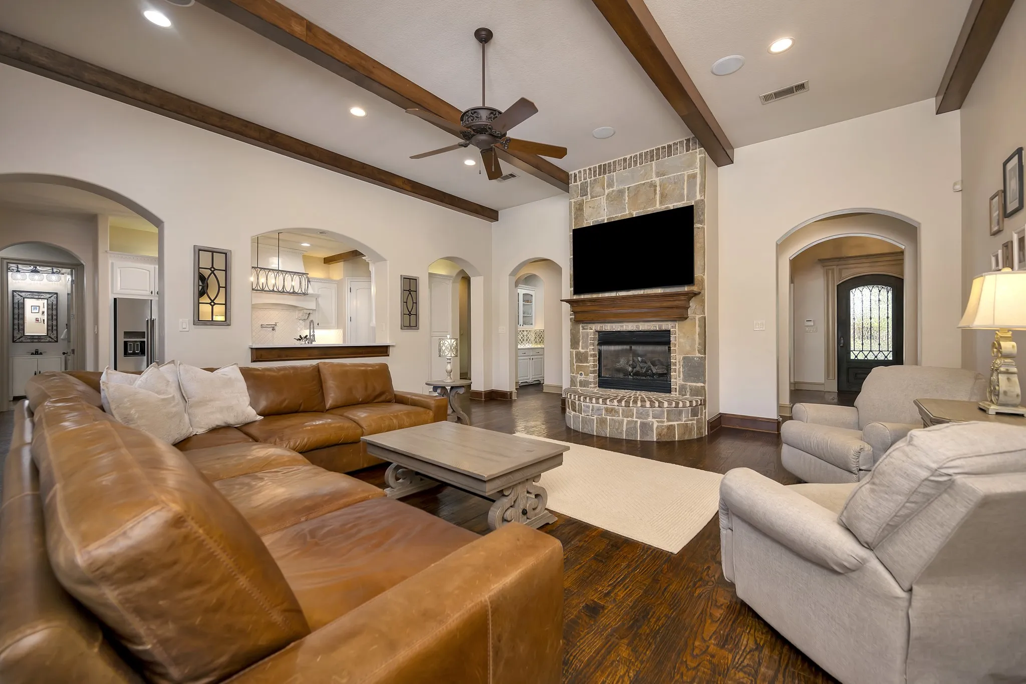 Open to the Kitchen with Gas Log Fireplace, Handscraped wood floors, Wall of Windows and Room for Everyone!
