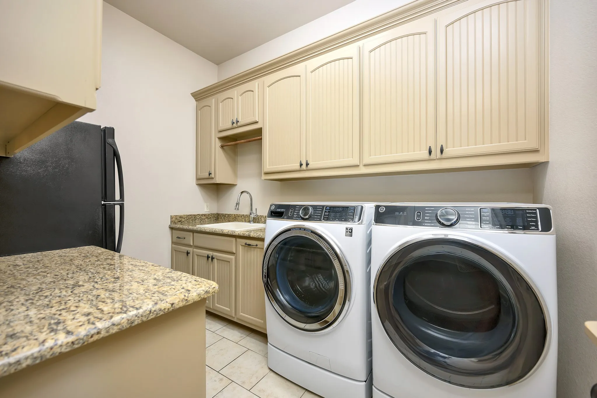This Laundry Room has it All!  Sink, Room for Fridge or Freezer, Folding area, Tons of Cabinets and Space for Full size Washer-Dryer.