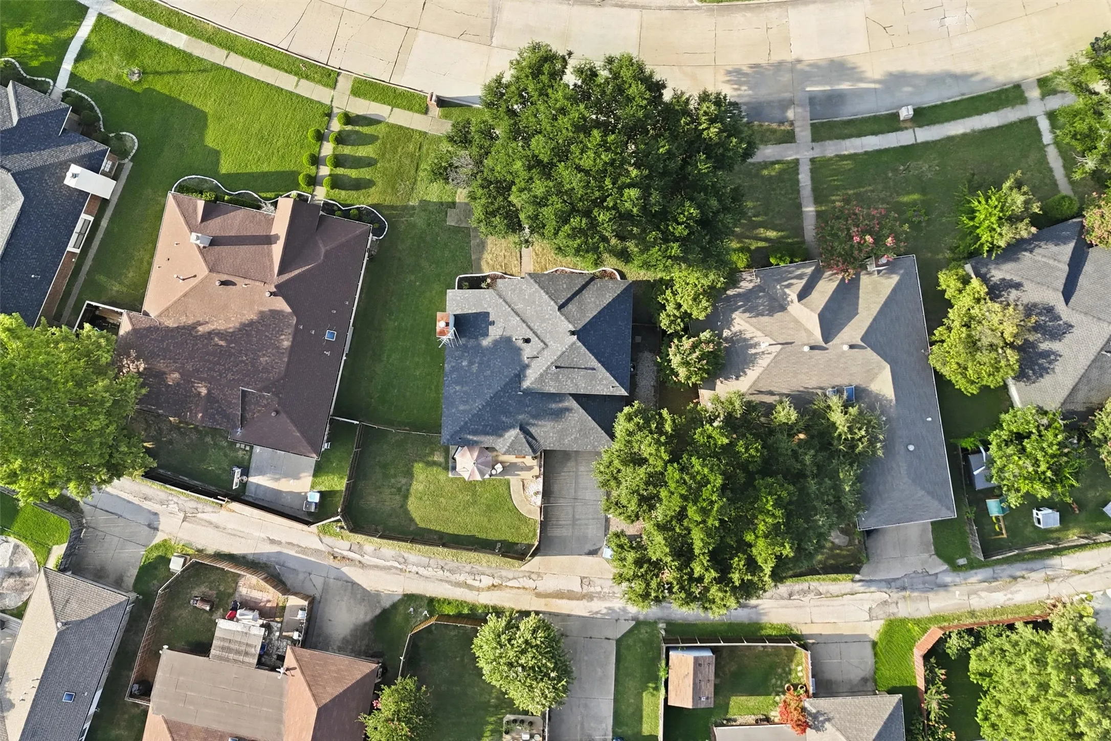 Aerial perspective showcasing a residential area with mature trees and established properties