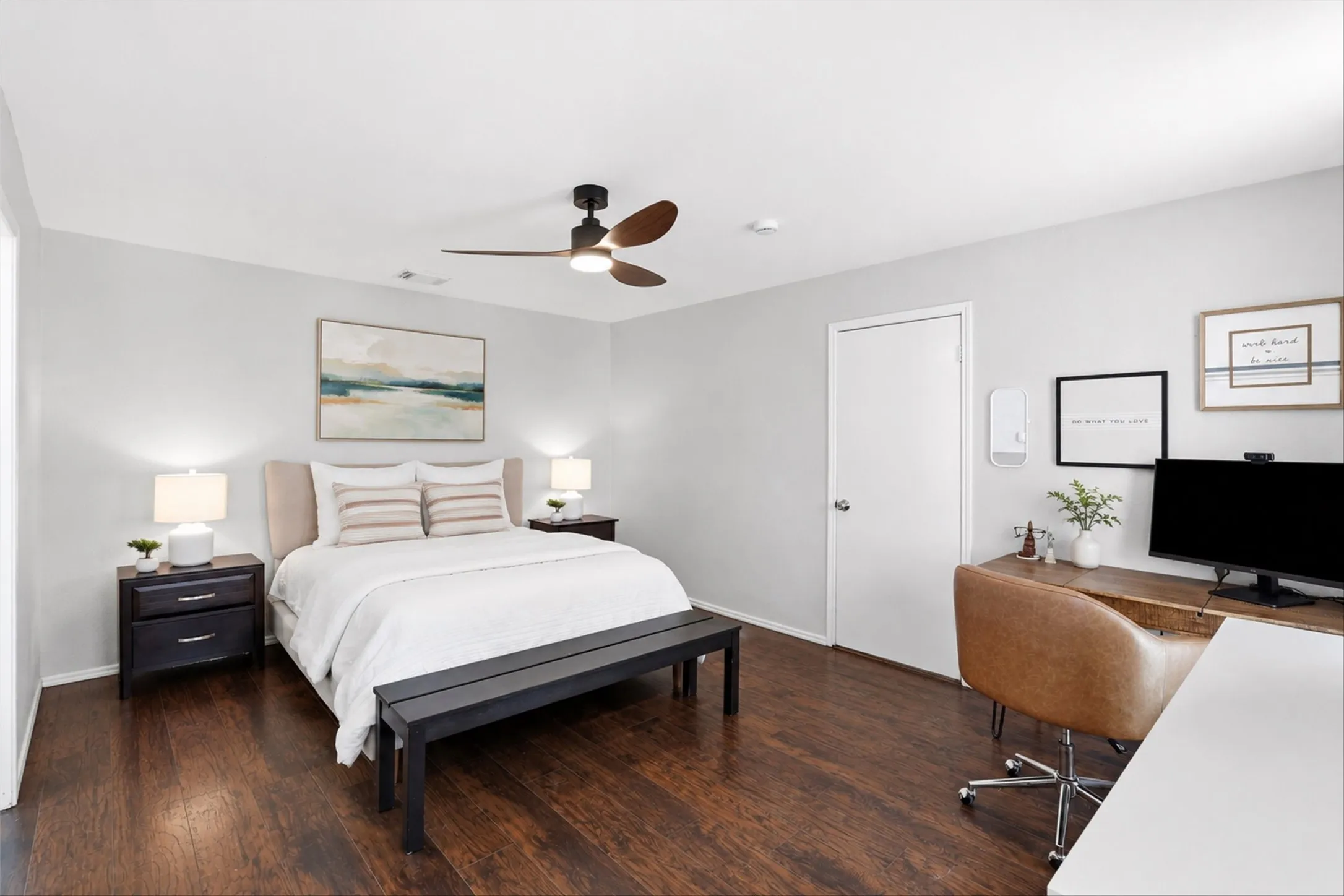 Spacious room featuring rich wood-finish flooring and light gray walls
