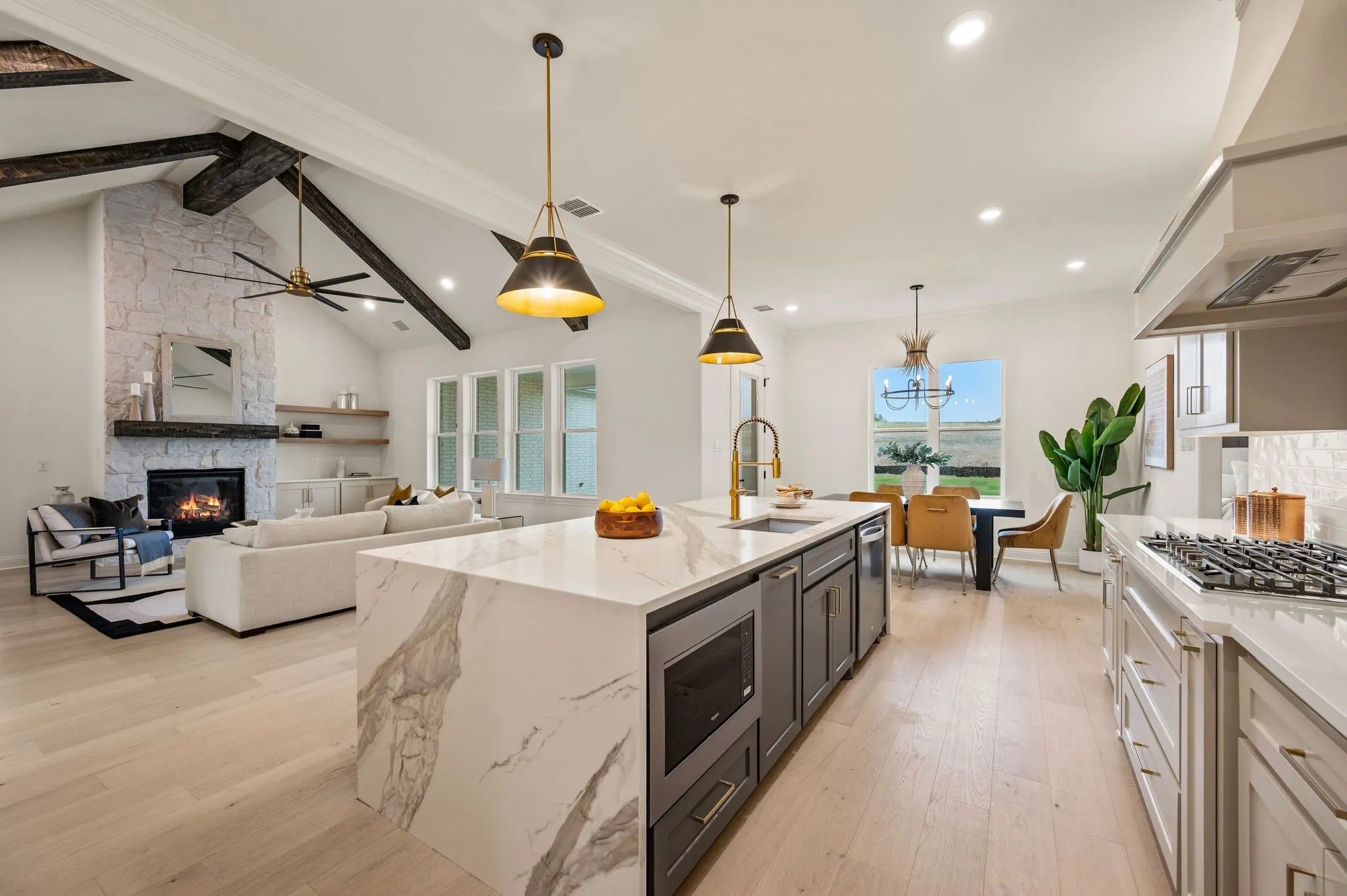 Open-concept living space with light wood-finish flooring
