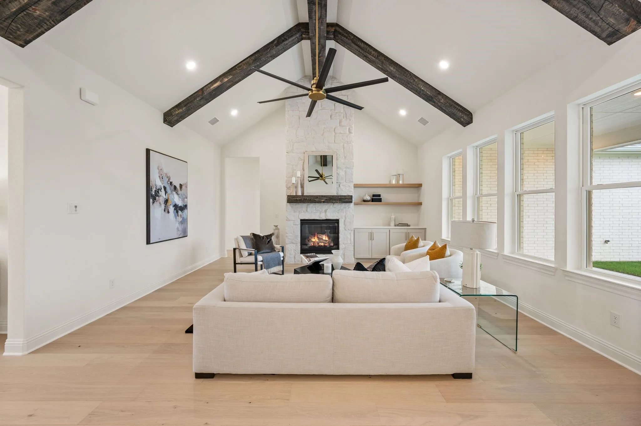 Vaulted ceiling with exposed wood beams and central ceiling fan
