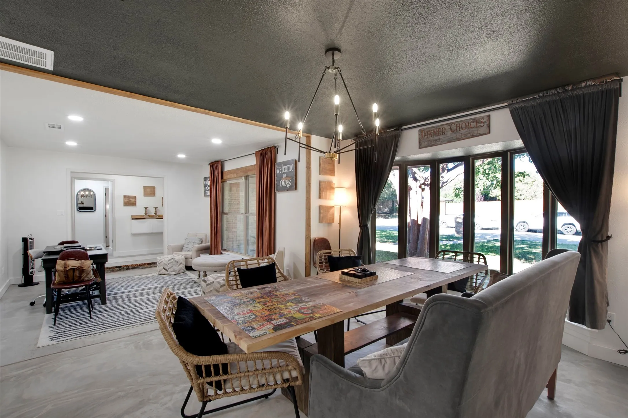 Dining area featuring a textured ceiling, a notable chandelier, and french doors