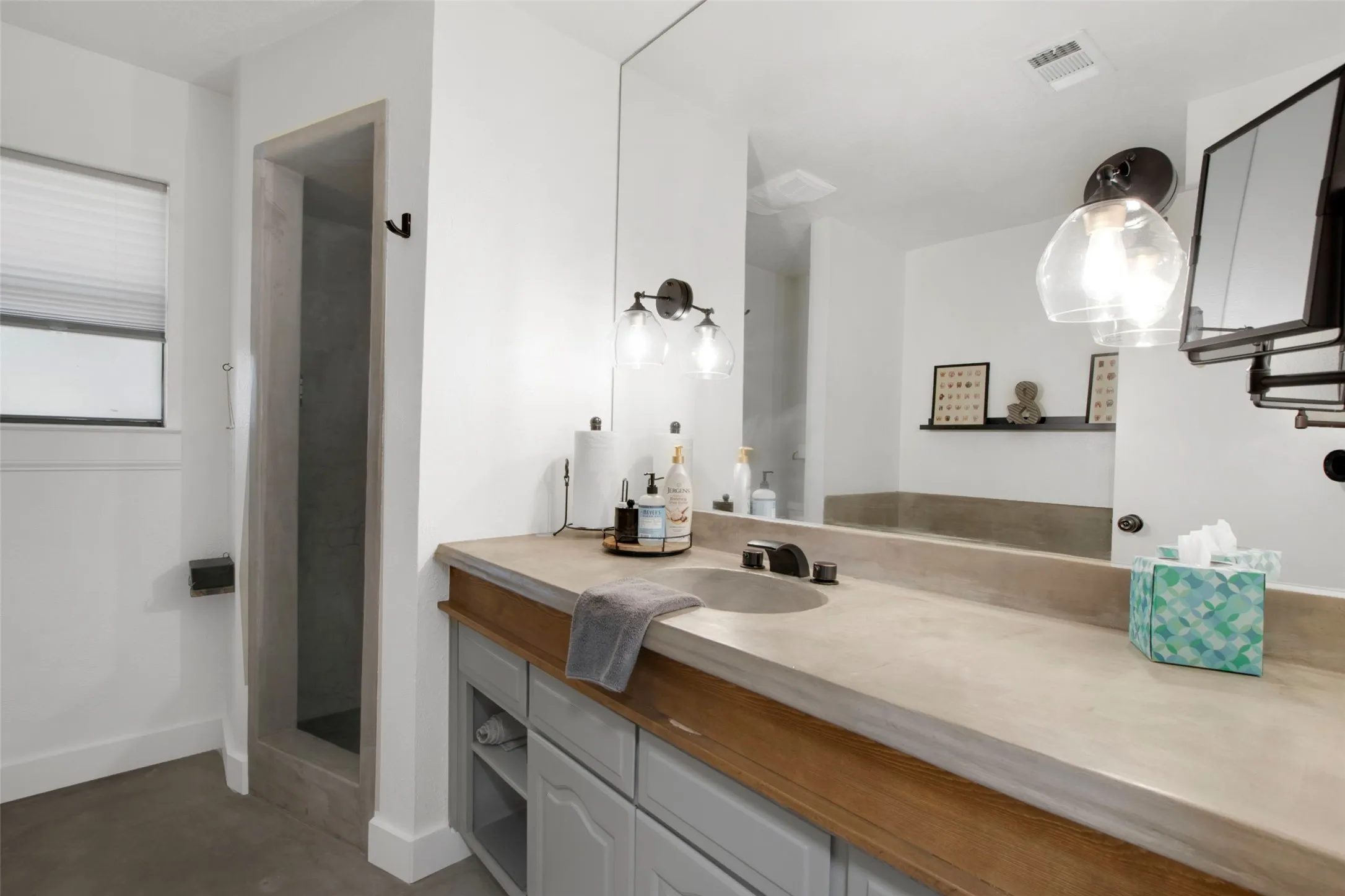 Bathroom featuring concrete flooring and vanity