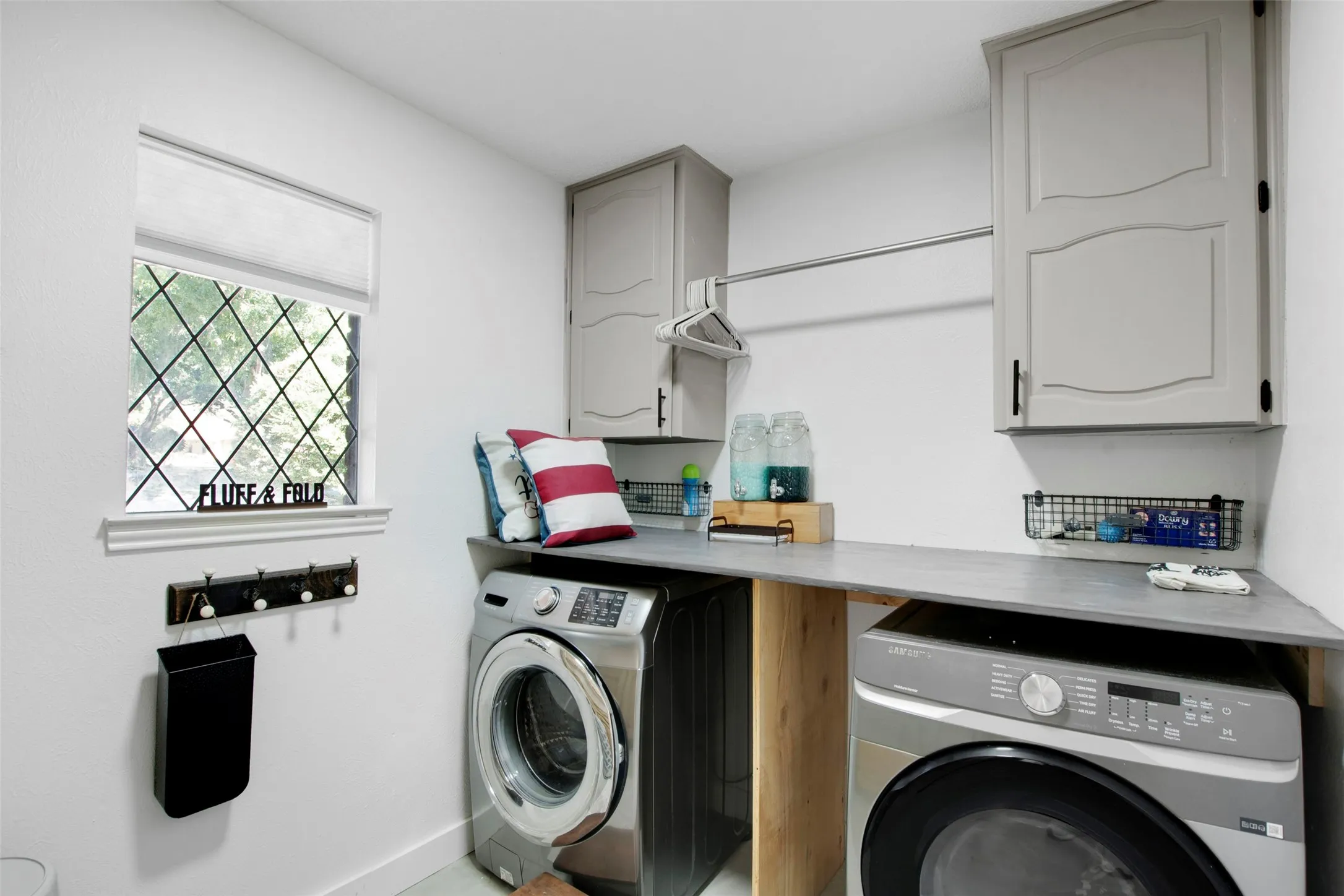 Laundry area featuring cabinets and washer and dryer