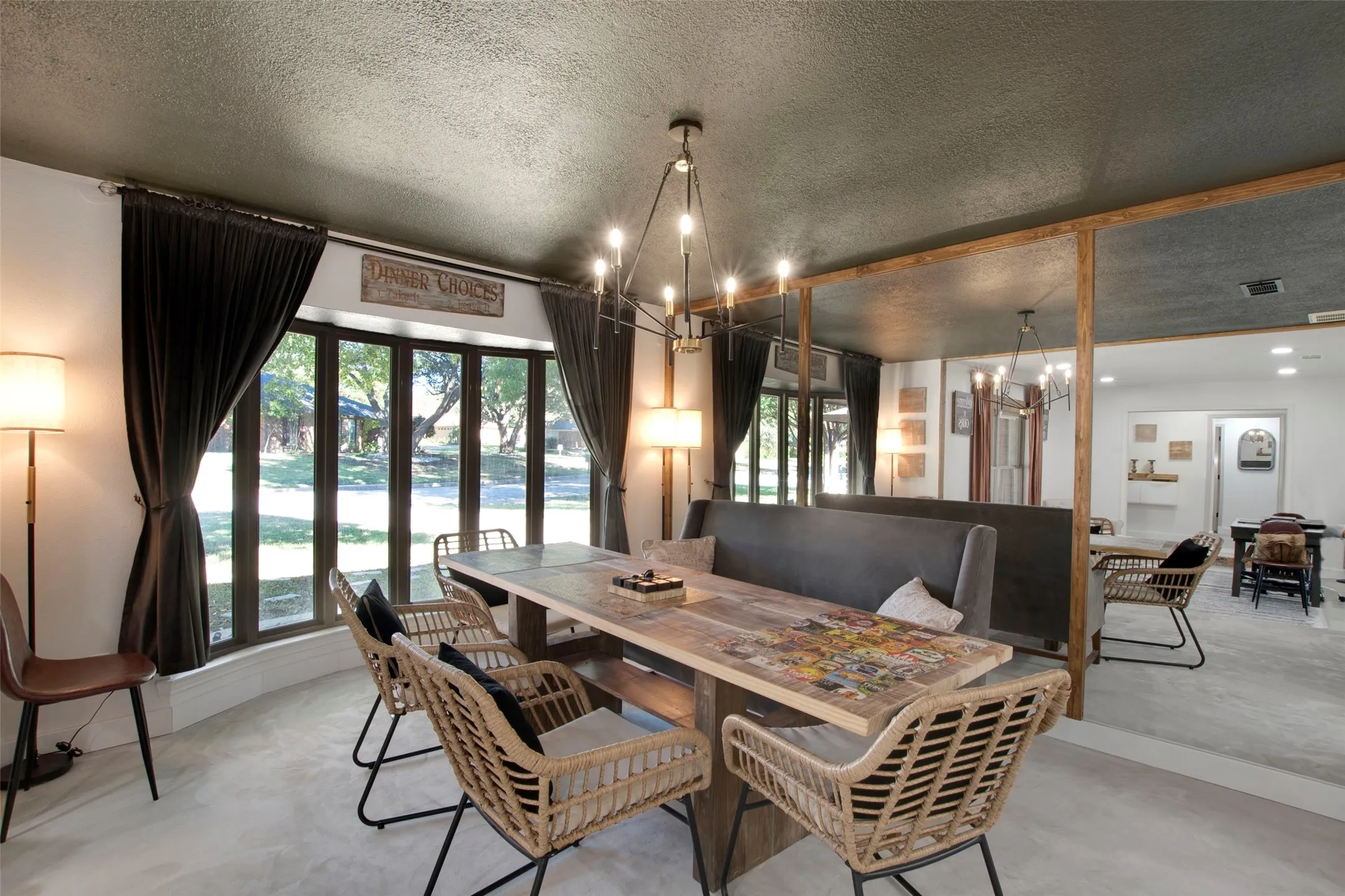 Dining space featuring a chandelier, a textured ceiling, and french doors